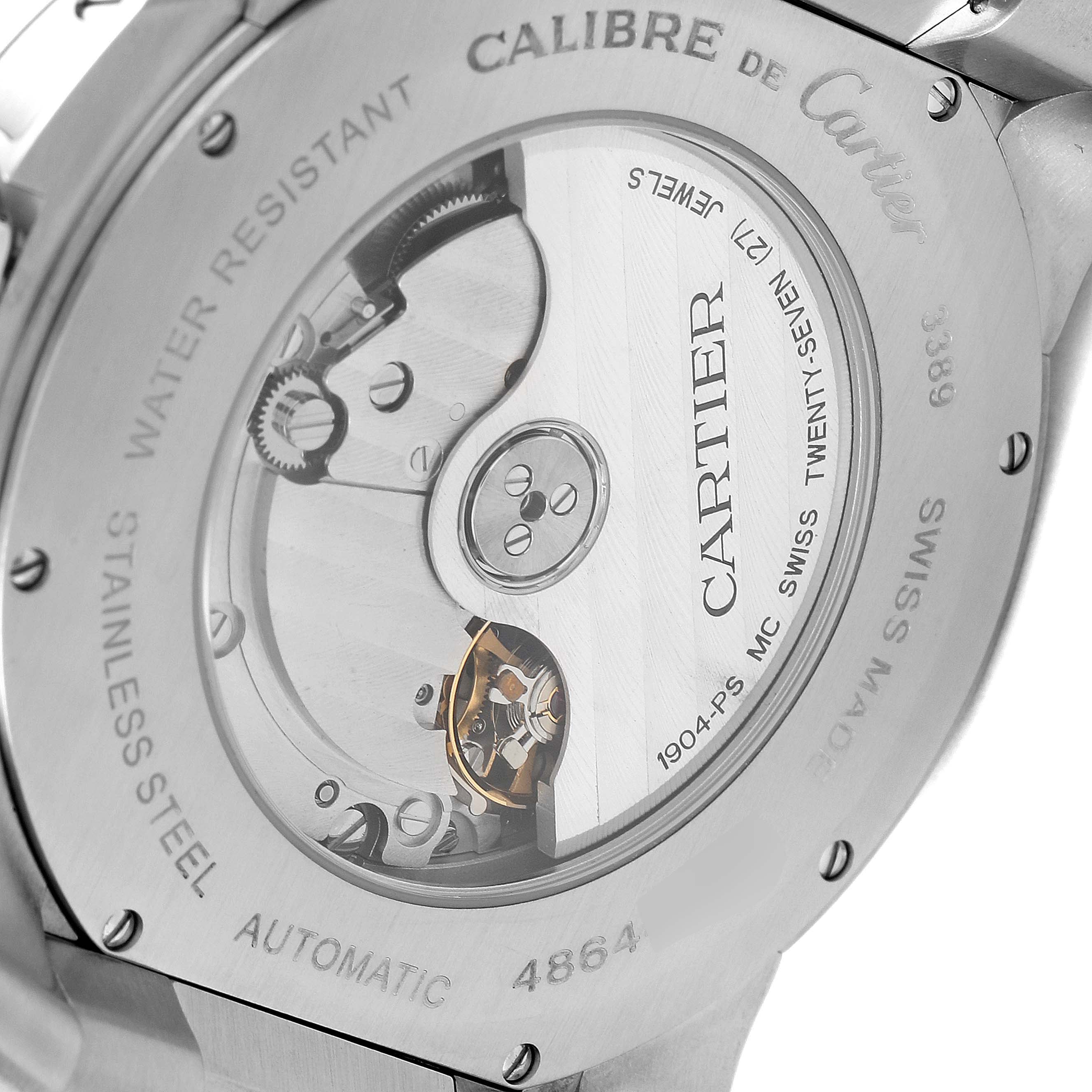 The image shows the case back of a Calibre de Cartier watch, revealing its automatic movement and internal mechanisms.