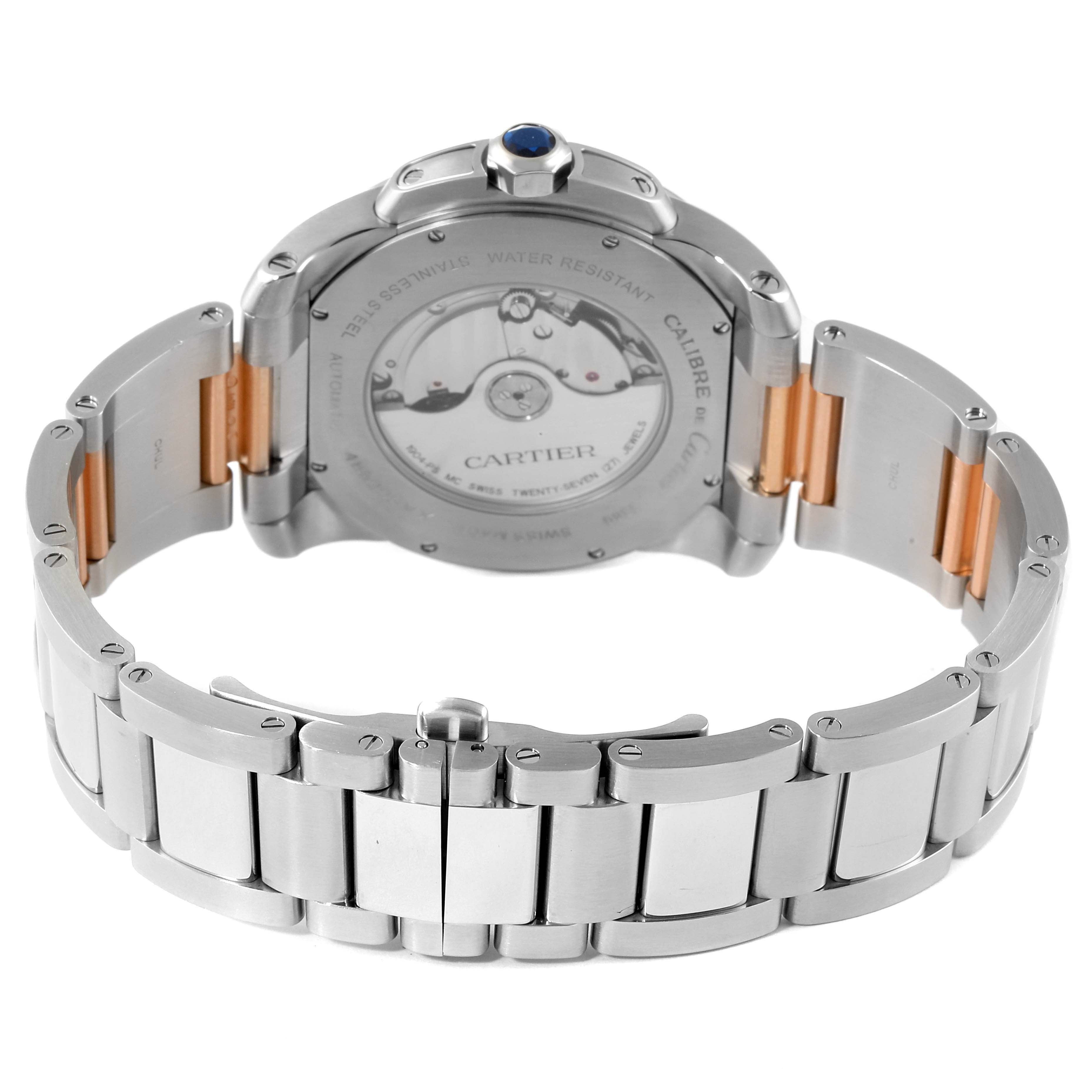 This image shows the back view of a Calibre de Cartier watch by Cartier, highlighting its stainless steel bracelet and transparent case back.