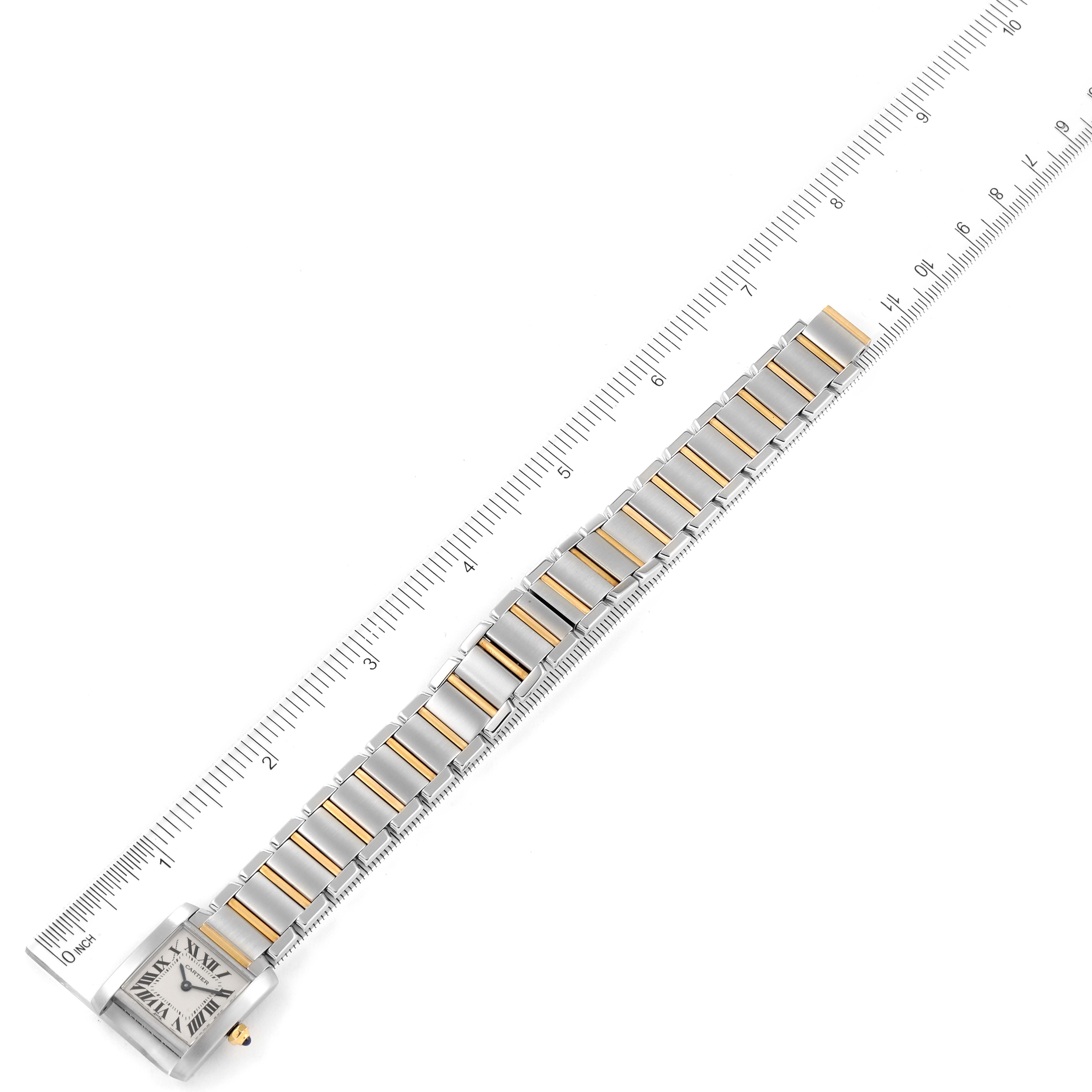 The image shows a parallel view of the Cartier Tank Francaise W51007Q4 Women's Steel and Gold (two tone) Silver Dial W51007Q4 Women's Steel and Gold (two tone) Silver Dial watch lying flat along a ruler.