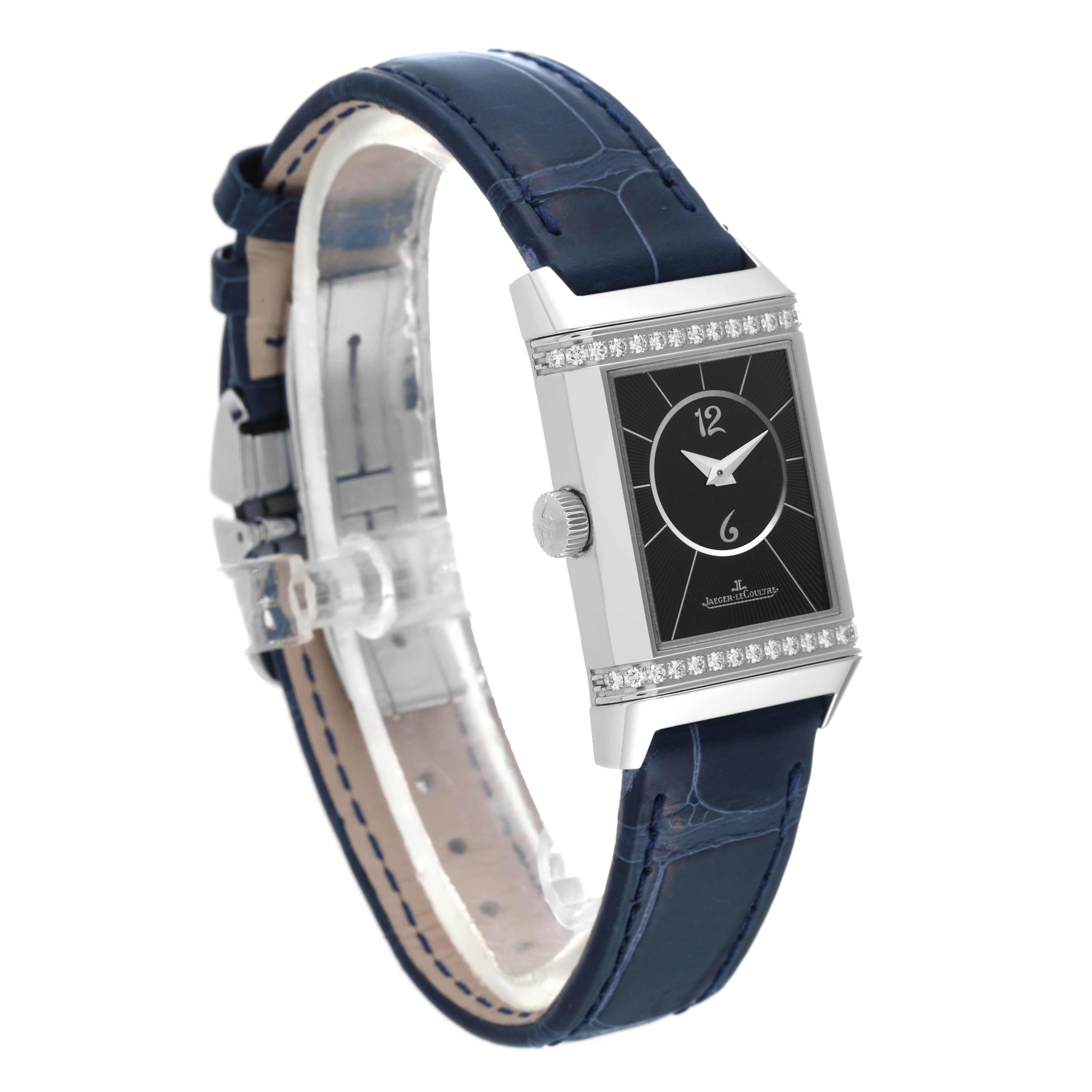 The image shows a Jaeger-LeCoultre Reverso watch at a side angle, highlighting the face, crown, and blue leather strap.