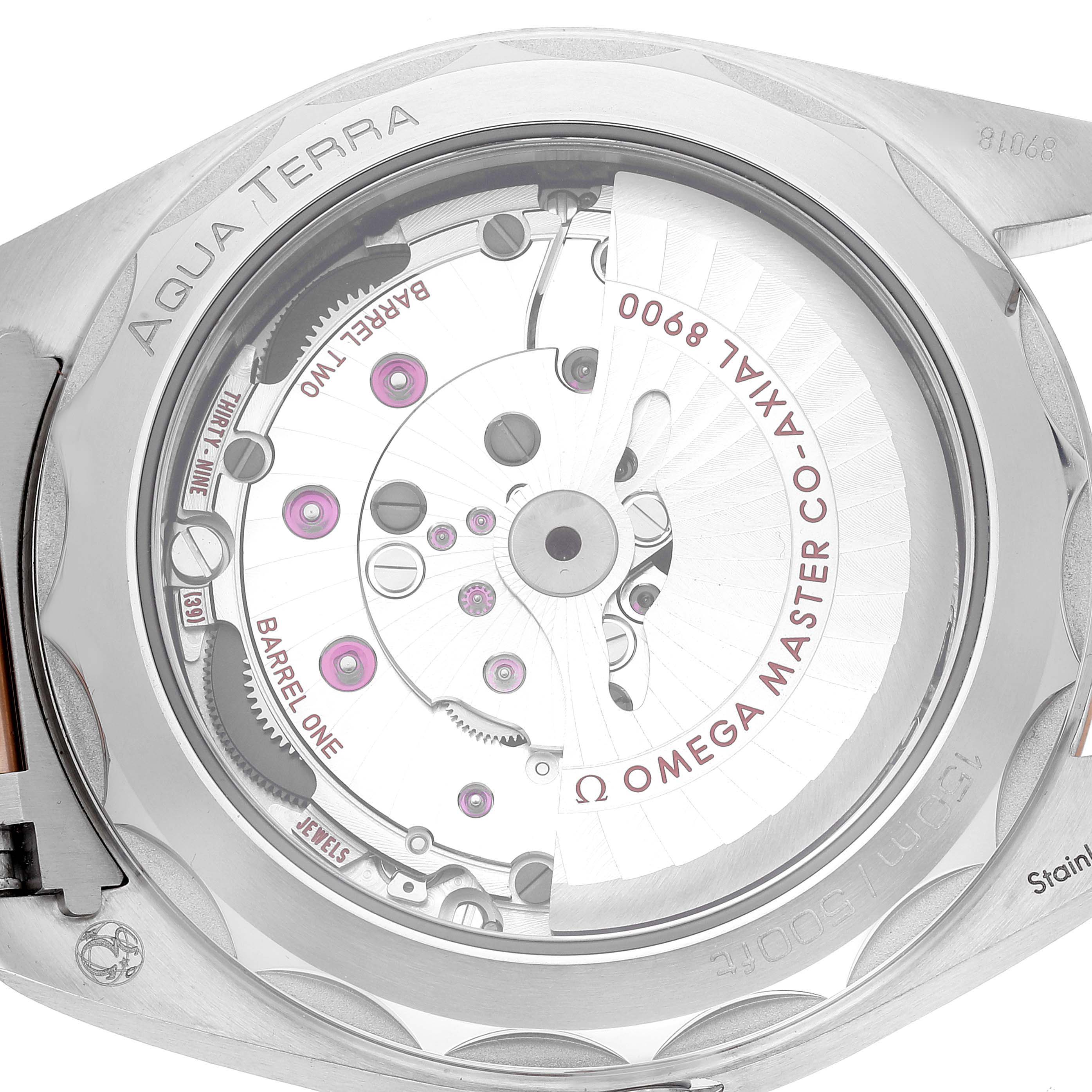 The image shows the back view of an Omega Aqua Terra 220.20.41.21.06.001 Men
s Steel and Gold (two tone) Grey Dial 220.20.41.21.06.001 Men
s Steel and Gold (two tone) Grey Dial watch, highlighting its movement and inner mechanisms.