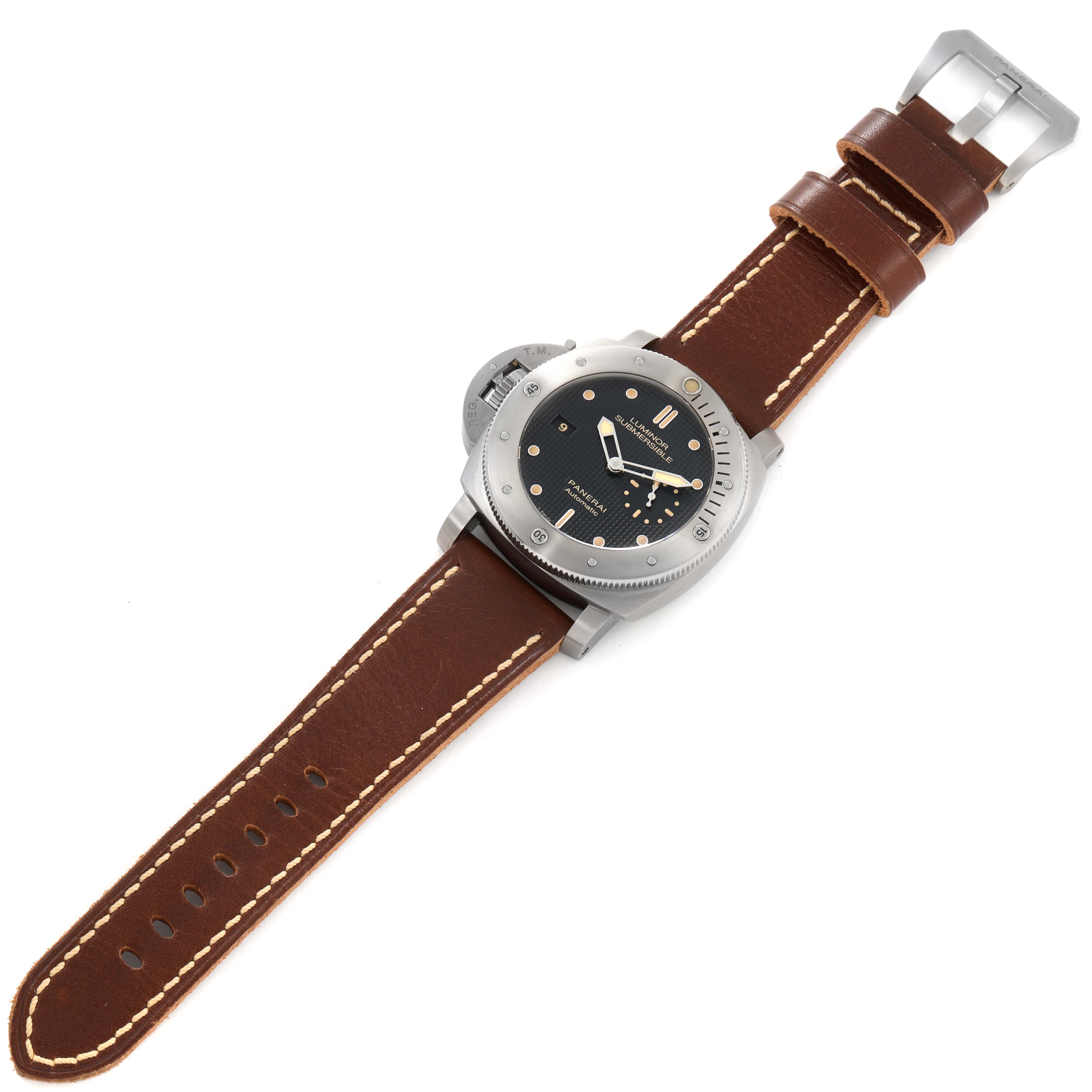 The image shows a top view of a Panerai Submersible PAM00569 Men's Titanium Black Dial PAM00569 Men's Titanium Black Dial watch with a brown leather strap and buckle.