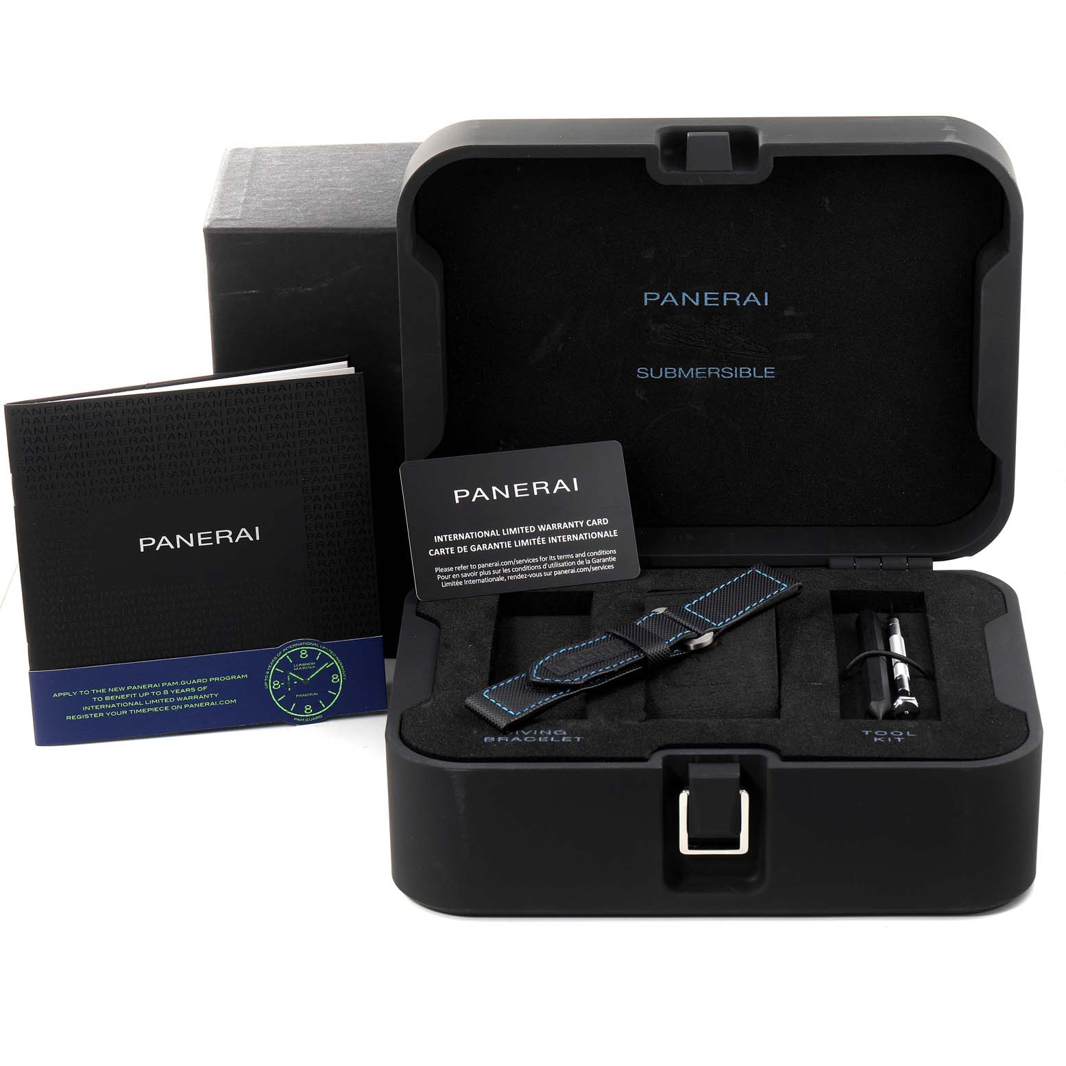 The image shows a Panerai Submersible PAM00973 Men
s Stainless Steel Black Dial PAM00973 Men
s Stainless Steel Black Dial watch case, extra strap, a tool kit, warranty card, manuals, and the outer box from a front angle.