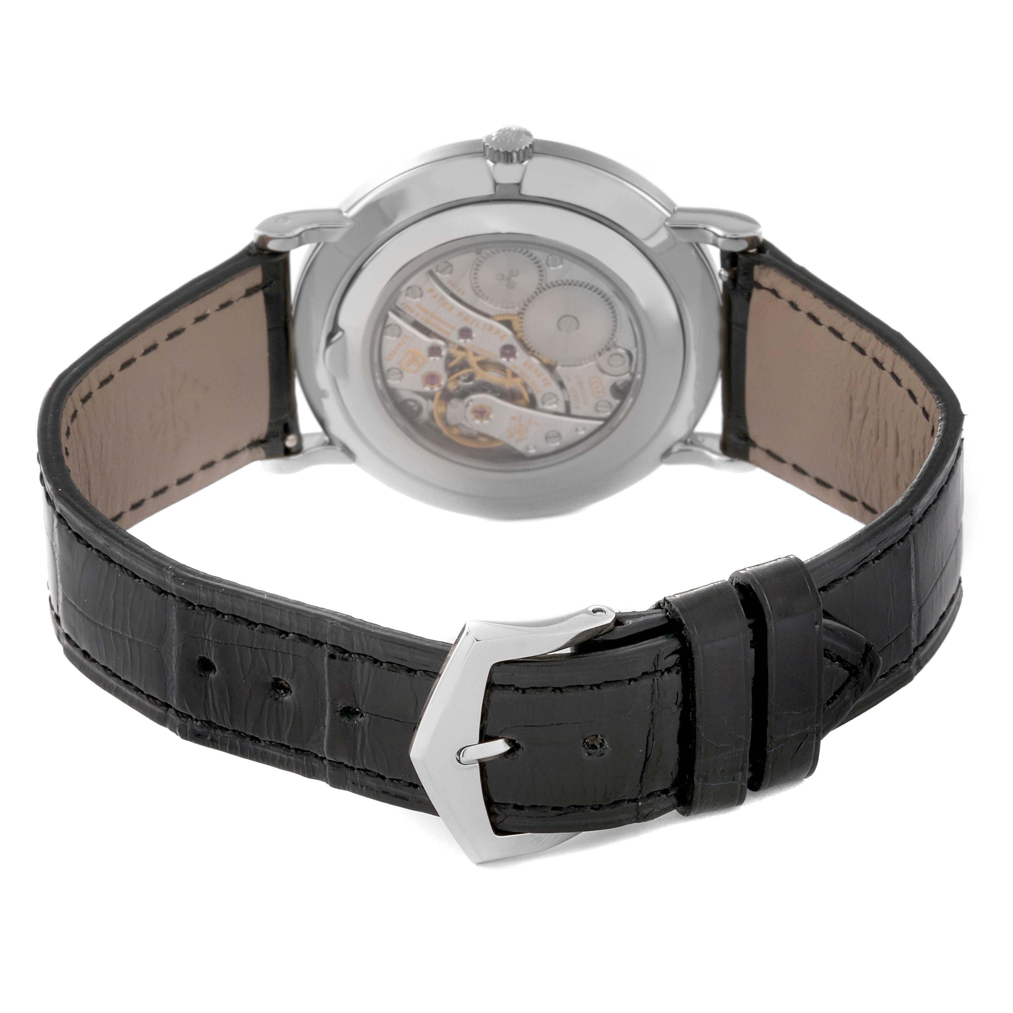 The image shows the back view of a Patek Philippe Calatrava 5119G Men's Yellow Gold White Dial 5119G Men's Yellow Gold White Dial watch, focusing on the movement and black leather strap.