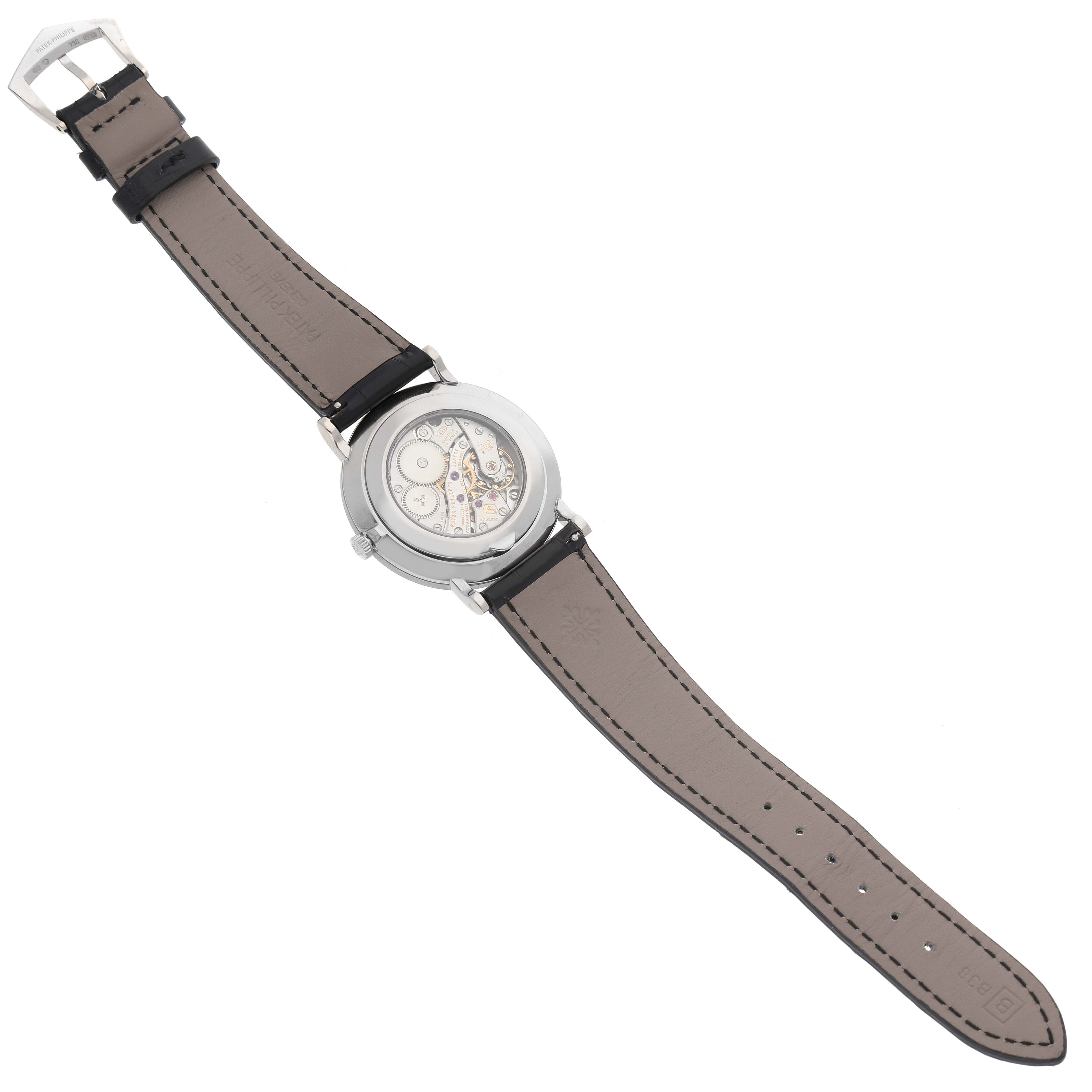 The image shows the back view of a Patek Philippe Calatrava 5119G Men's Yellow Gold White Dial 5119G Men's Yellow Gold White Dial watch, displaying the movement and leather strap.