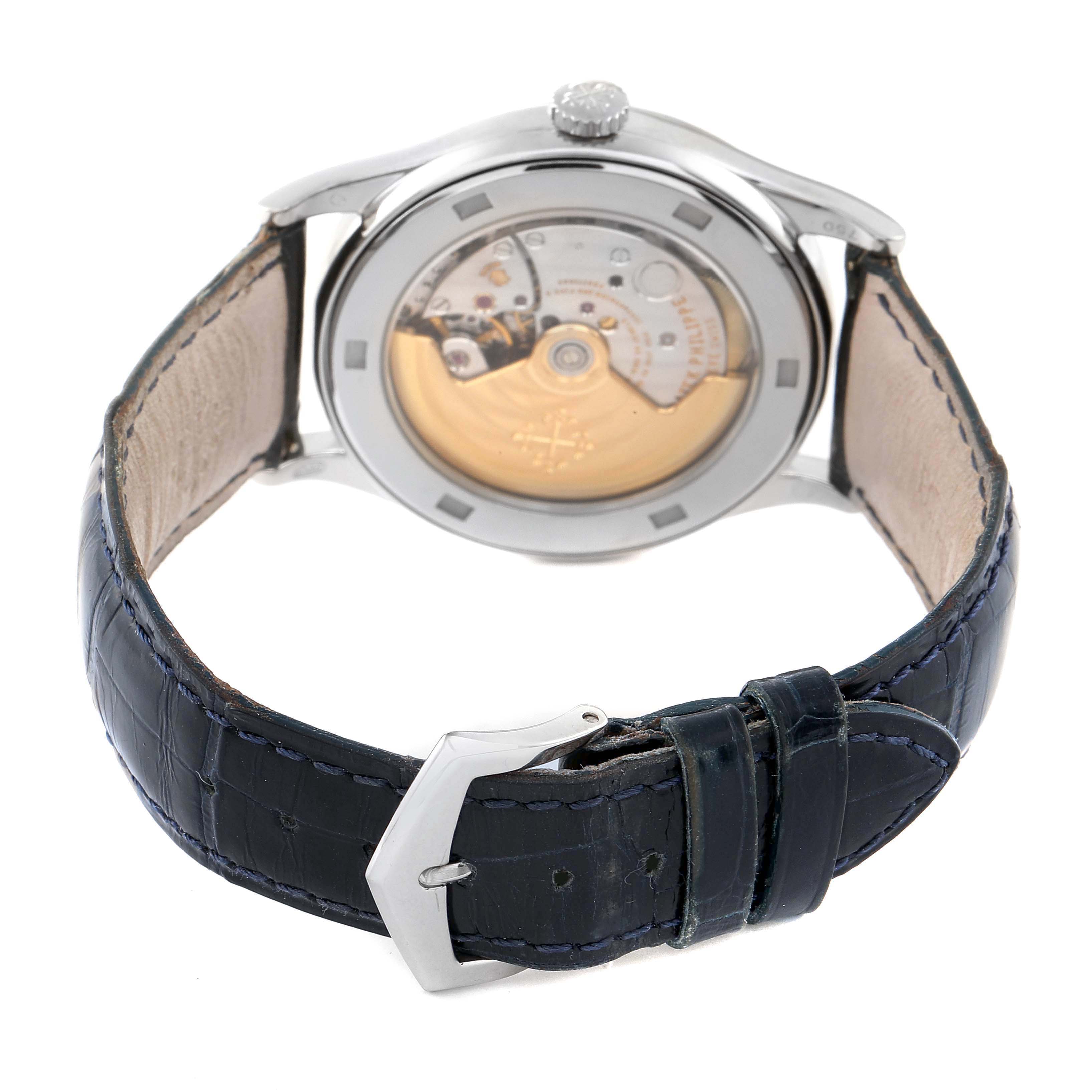 The image shows the back side of a Patek Philippe Calatrava 5296G-001 Men's White Gold Silver Dial watch, highlighting its movement and leather strap.