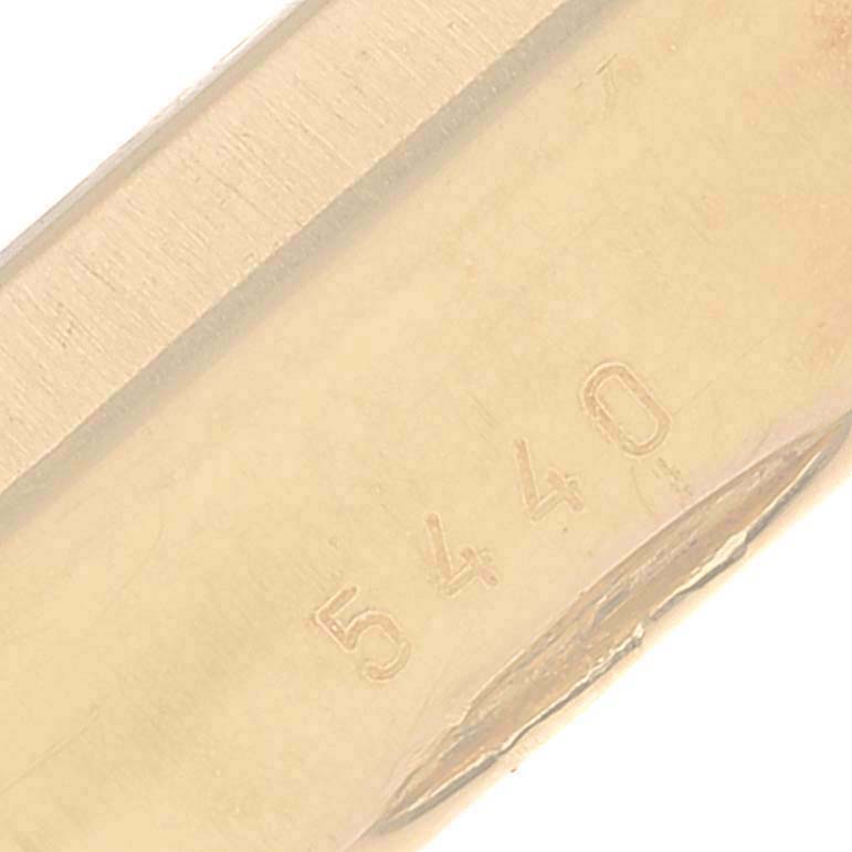 This close-up shows the engraved serial number on the gold case of a Rolex Cellini 5440/8 Men
s Yellow Gold Champagne Dial 5440/8 Men
s Yellow Gold Champagne Dial model watch.