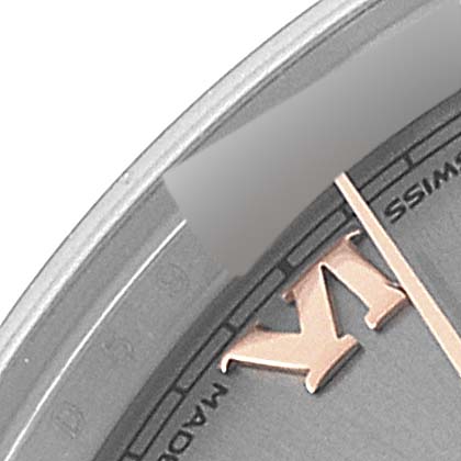 This close-up image shows a portion of the mid-size Rolex watch face, including part of an hour marker and the edge of the dial.