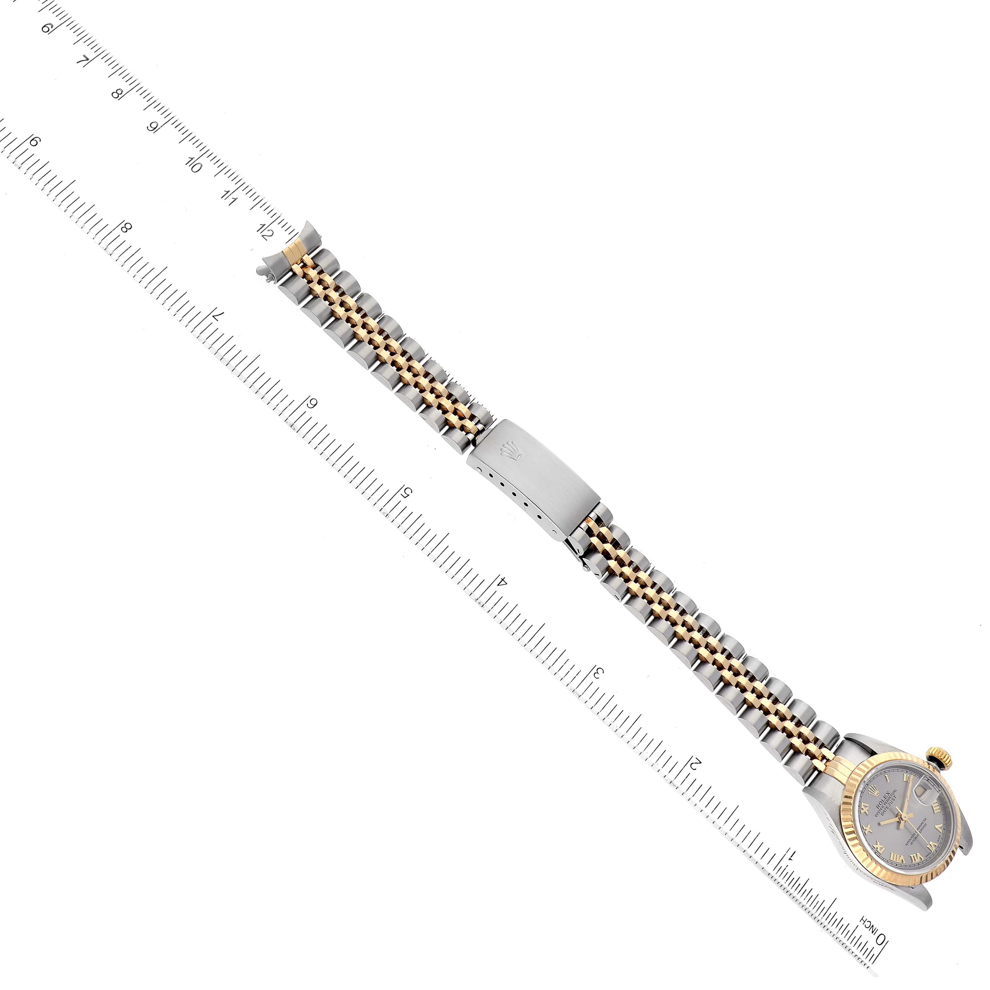 The image shows a Rolex Datejust 69173 Women's Steel and Gold (two tone) Grey Dial 69173 Women's Steel and Gold (two tone) Grey Dial watch laid flat, with a ruler for scale, displaying the watch face, crown, and two-tone bracelet.