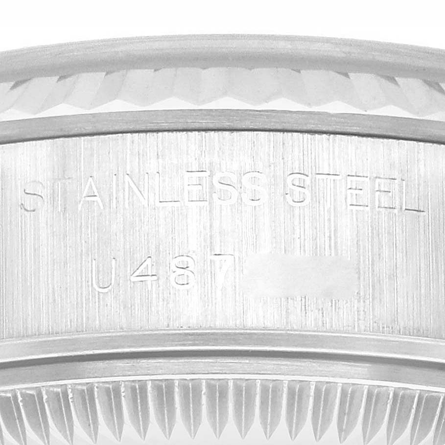 This image shows a close-up of the stainless steel bezel and engraved serial number on a Rolex Datejust 69174 Women's Stainless Steel Silver Dial 69174 Women's Stainless Steel Silver Dial watch.