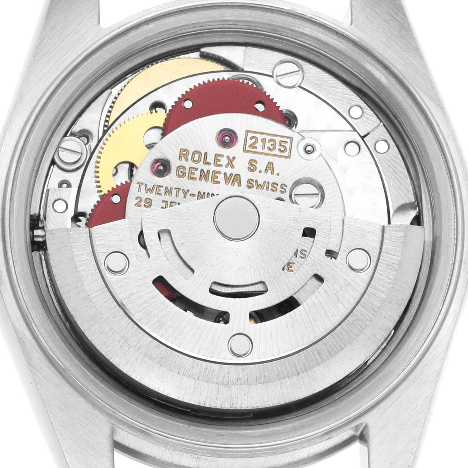 The image displays the movement mechanism of a Rolex Datejust 69174 Women's Stainless Steel Silver Dial 69174 Women's Stainless Steel Silver Dial watch from a rear angle, showcasing internal gears and inscriptions.