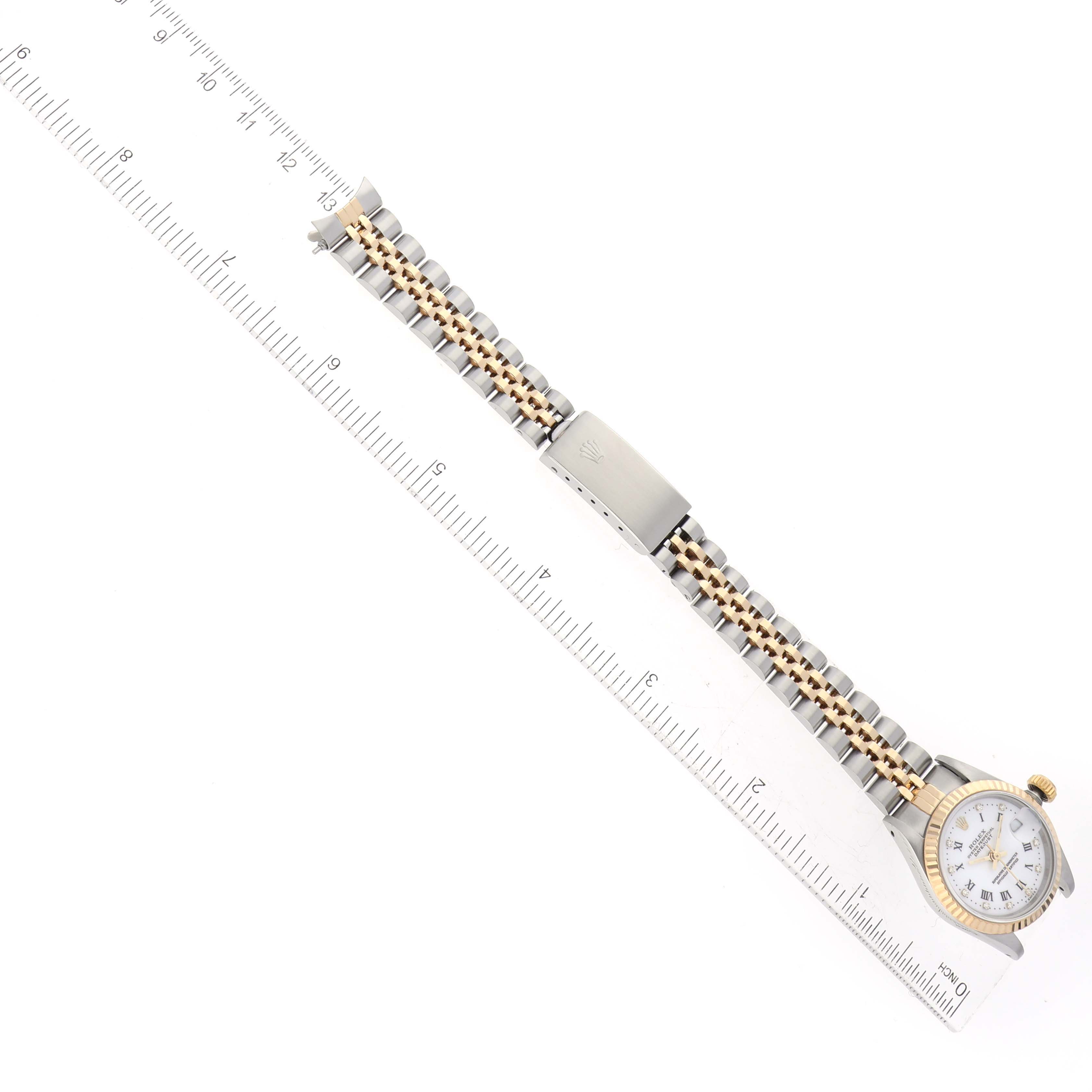 This image shows a Rolex Datejust 69173G Women's Steel and Gold (two tone) White Dial 69173G Women's Steel and Gold (two tone) White Dial watch laid flat with the face and bracelet fully visible alongside a ruler.