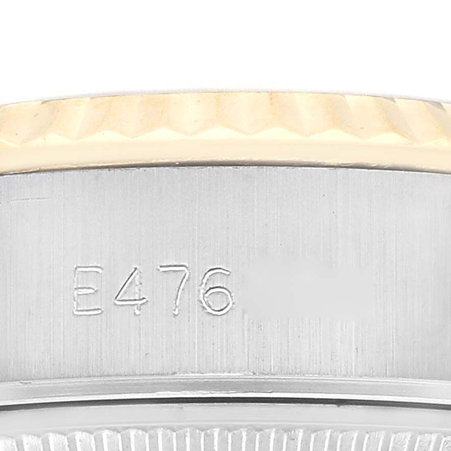 This is a close-up view of the Rolex Datejust 69173G Women's Steel and Gold (two tone) White Dial 69173G Women's Steel and Gold (two tone) White Dial with focus on its case and serial number engraving.