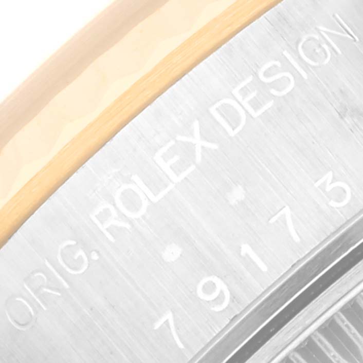 The image shows a close-up of the case edge from a Rolex Datejust 79173 Women's Steel and Gold (two tone) Grey Dial 79173 Women's Steel and Gold (two tone) Grey Dial, highlighting the engraved text "ORG. ROLEX DESIGN" and partially visible serial number.