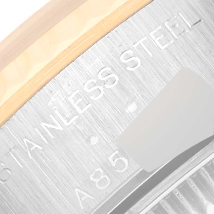 The image shows a close-up of the edge of the bezel and part of the case back of a Rolex Datejust 79173 Women's Steel and Gold (two tone) Grey Dial 79173 Women's Steel and Gold (two tone) Grey Dial watch, highlighting the words "STAINLESS STEEL."