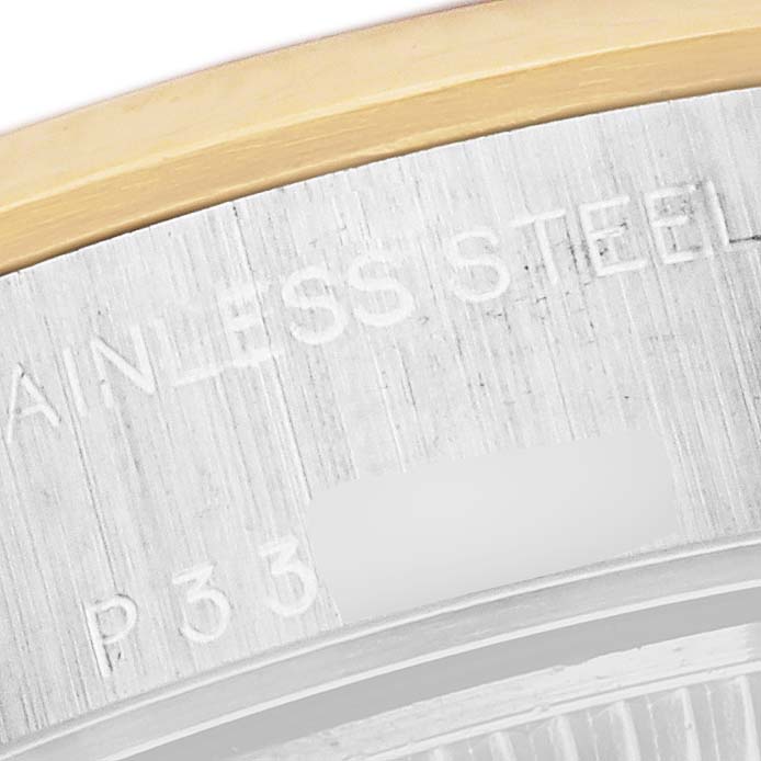 This close-up of the Rolex Datejust 79163 Women's Steel and Gold (two tone) White Dial 79163 Women's Steel and Gold (two tone) White Dial model shows part of the caseback edge with "STAINLESS STEEL" engraving and a partial model number.