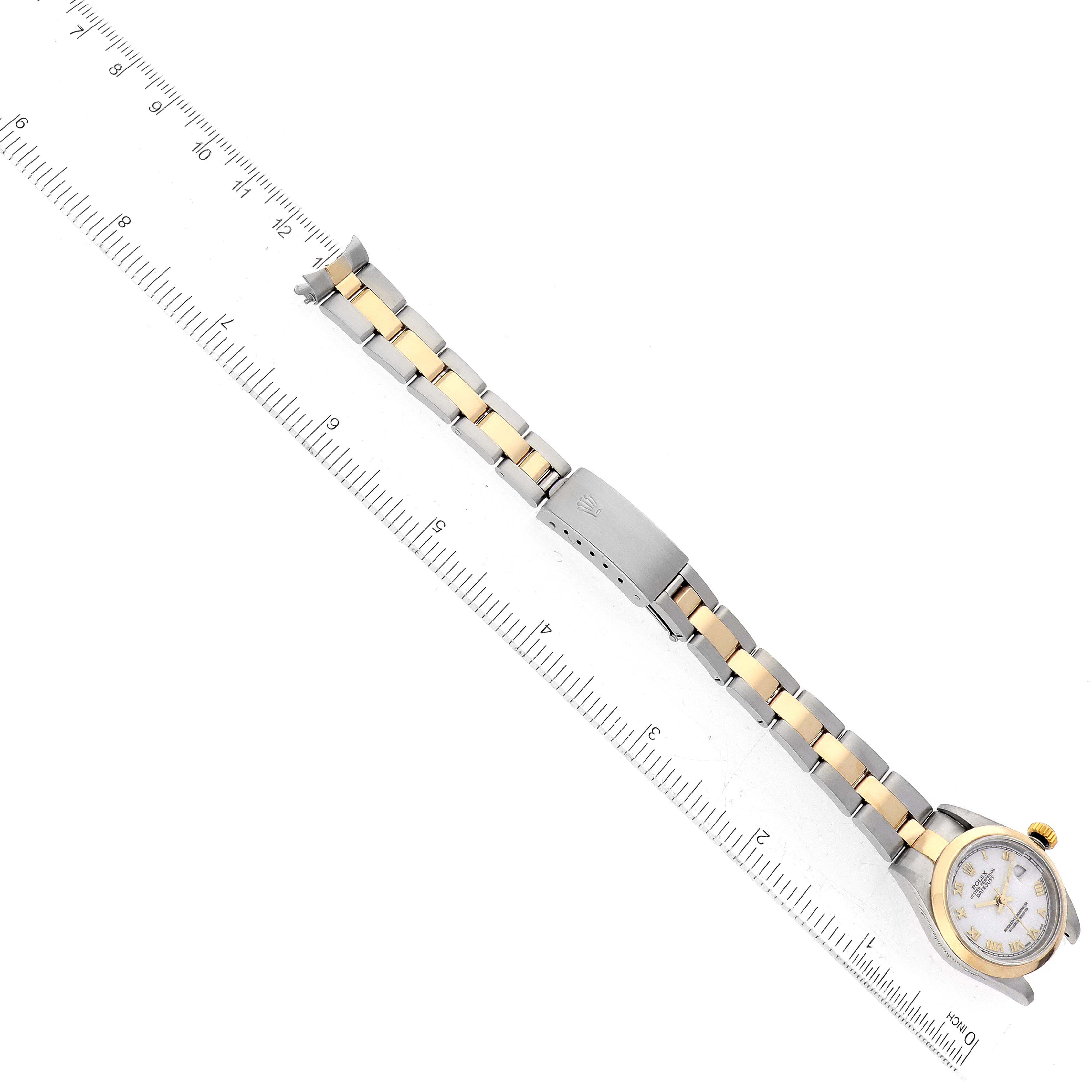 The image shows a Rolex Datejust 79163 Women's Steel and Gold (two tone) White Dial 79163 Women's Steel and Gold (two tone) White Dial watch laid flat, highlighting its dial, bezel, and two-tone bracelet, next to a ruler for size reference.