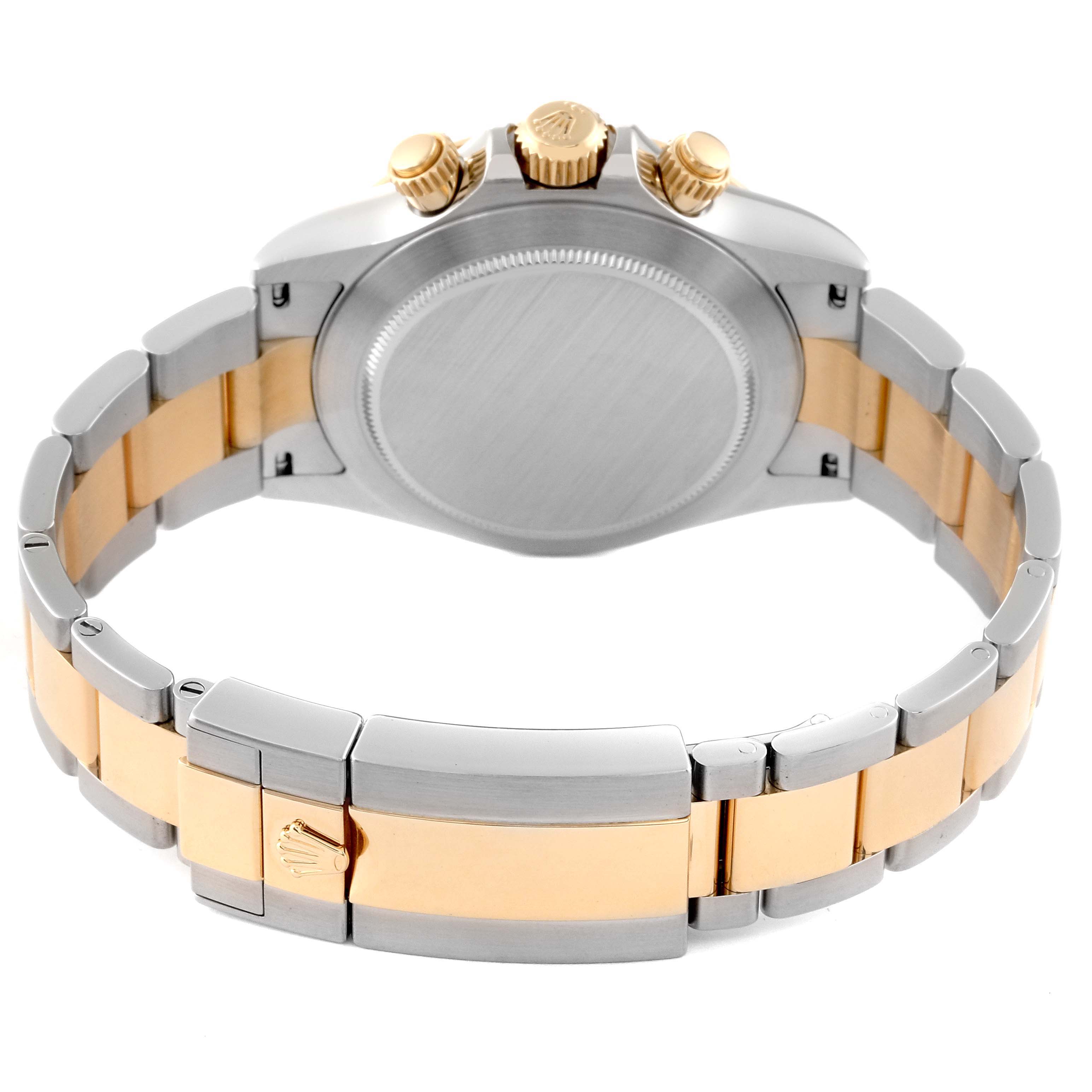 The image shows the back view of a Rolex Daytona 116503 Men
s Steel and Gold (two tone) Mother of Pearl Dial 116503 Men
s Steel and Gold (two tone) Mother of Pearl Dial watch, highlighting the stainless steel and gold bracelet and the crown.