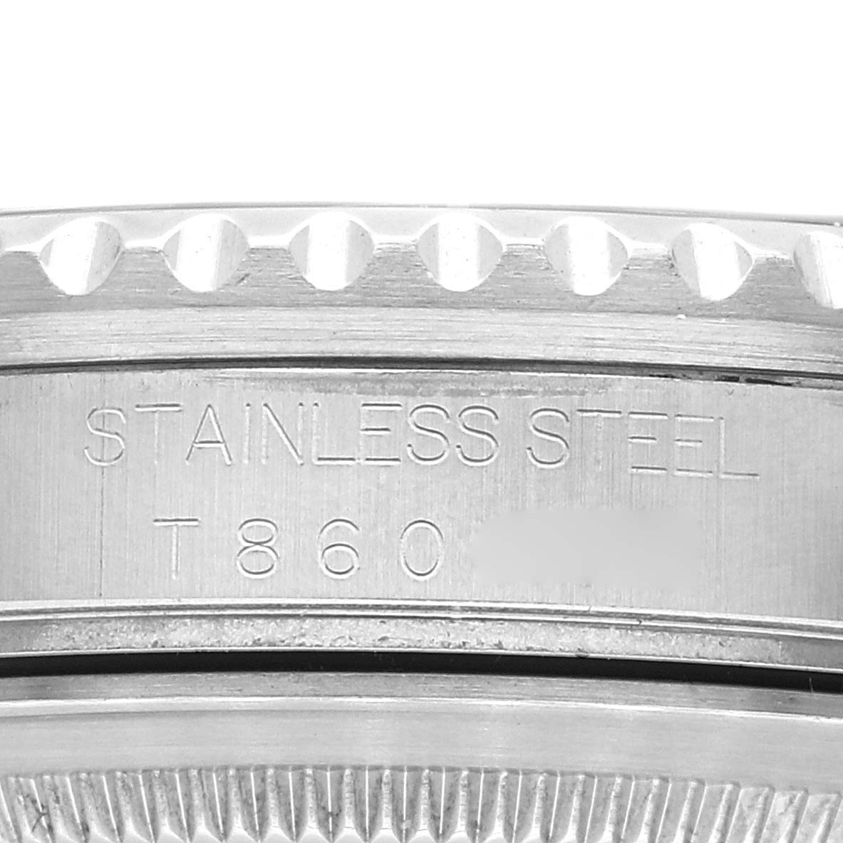 The image shows a close-up of the side of the bezel and case of a Rolex GMT-Master 16700 Men
s Stainless Steel Black Dial 16700 Men
s Stainless Steel Black Dial watch, highlighting the stainless steel engraving and serial number.