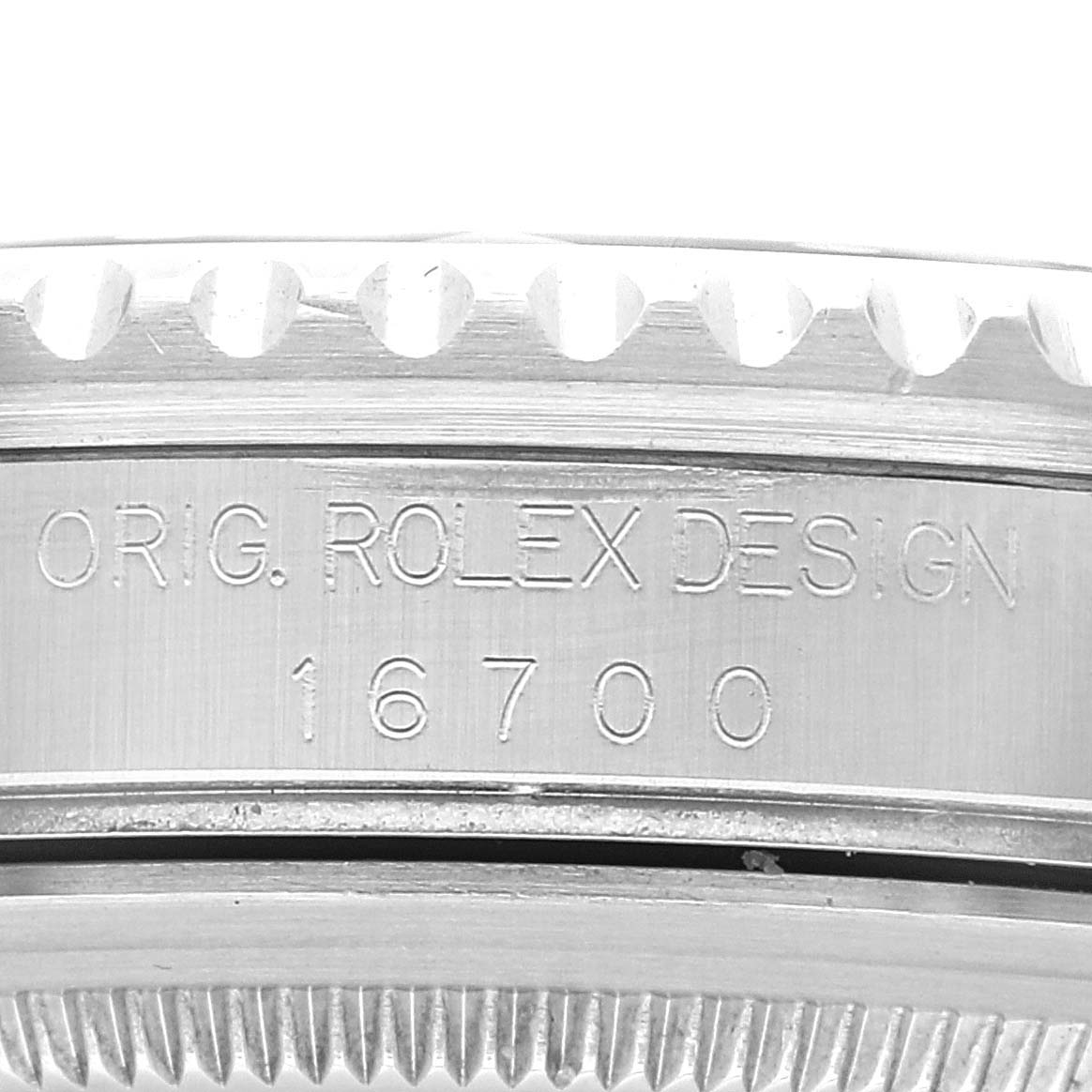 The image shows a close-up of the engraved side of the Rolex GMT-Master 16700 Men
s Stainless Steel Black Dial 16700 Men
s Stainless Steel Black Dial watch case, displaying the model number 16700.
