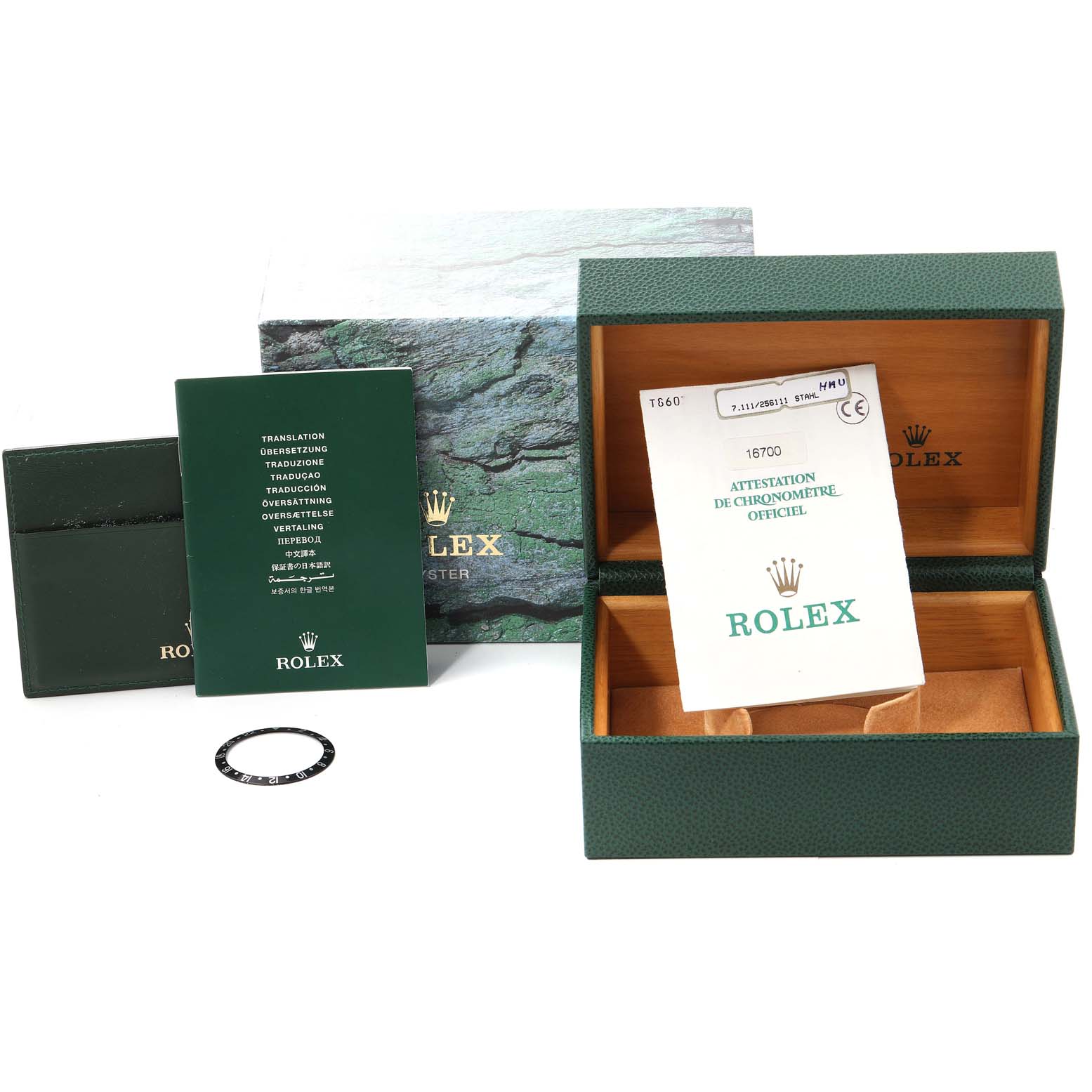 The image shows the packaging and accessories for a Rolex GMT-Master 16700 Men
s Stainless Steel Black Dial 16700 Men
s Stainless Steel Black Dial, including the box, booklet, insert, and certification paper.