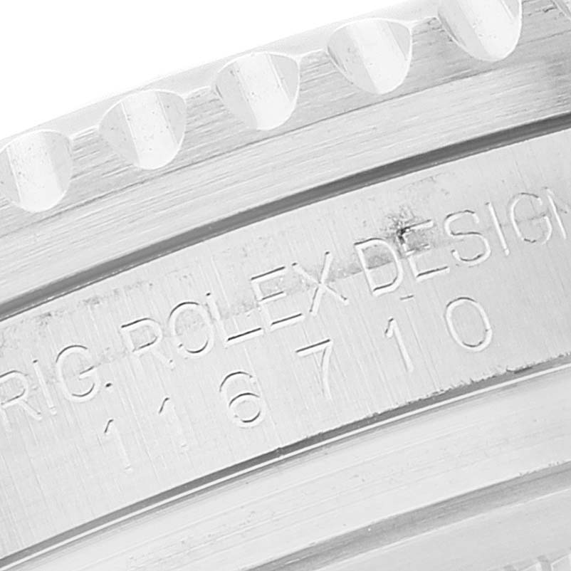 Close-up of the engraving on the side of a Rolex GMT-Master 116710 Men's Stainless Steel Black Dial 116710 Men's Stainless Steel Black Dial watch, highlighting the model number and "Rolex Design."