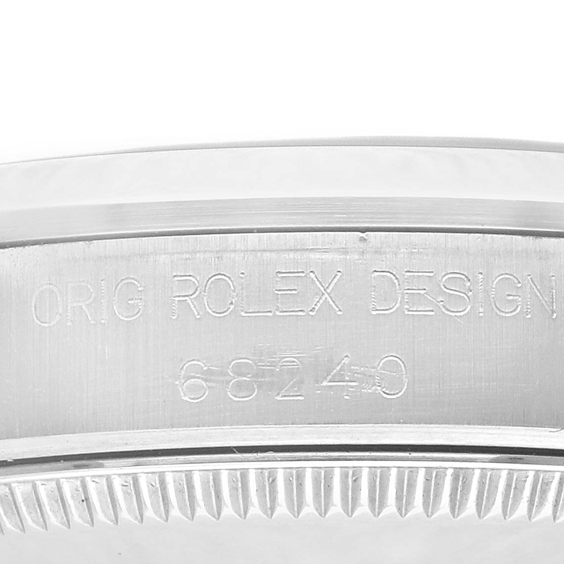 The image shows a macro shot of the serial and model number engraved on the side of the bezel of a Rolex Mid-Size 68240 Women's Stainless Steel Grey Dial 68240 Women's Stainless Steel Grey Dial watch.