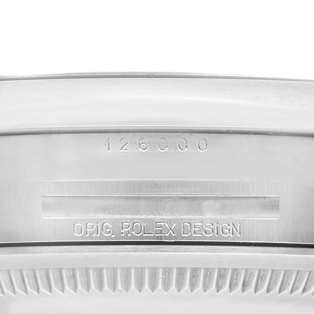 The photo shows the engraved side view of the bezel and case of a Rolex Oyster Perpetual 126000 Men's Stainless Steel Black Dial 126000 Men's Stainless Steel Black Dial model.