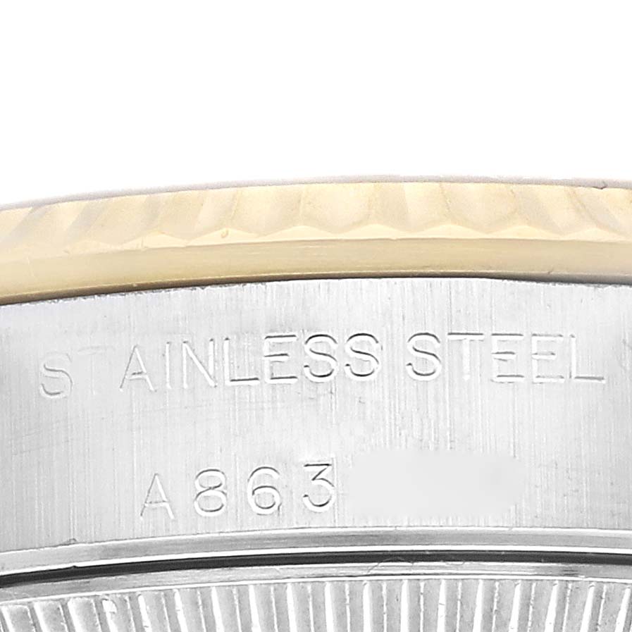 This close-up image shows the side case and the bezel of a Rolex Oyster Perpetual 76193 Women's Stainless Steel Grey Dial 76193 Women's Stainless Steel Grey Dial watch, highlighting the “STAINLESS STEEL” engraving.