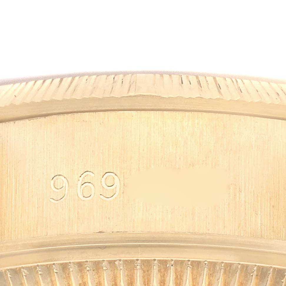 The image shows a close-up view of the side of a Rolex President 69278 Women's Yellow Gold White Dial 69278 Women's Yellow Gold White Dial model watch case, featuring its serial number partly visible.