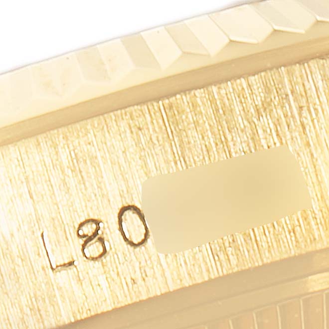 The image shows a close-up angle of the casing and part of the bezel of a Rolex President 69178 Women
s Yellow Gold Champagne Dial 69178 Women
s Yellow Gold Champagne Dial model watch, with visible engraved markings.