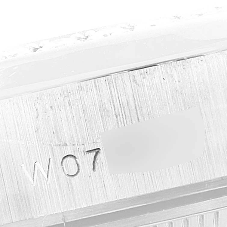 The image shows a close-up of the side of a Rolex President 69159 Women
s White Gold Silver Dial 69159 Women
s White Gold Silver Dial model watch, focused on the engraved serial number.