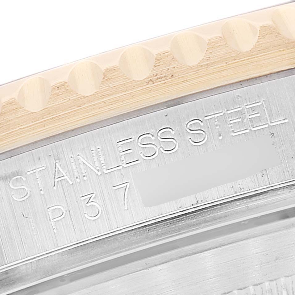 This close-up image shows the engraved stainless steel case and part of the bezel of a Rolex Submariner 16613 Men
s Steel and Gold (two tone) Blue Dial 16613 Men
s Steel and Gold (two tone) Blue Dial watch.