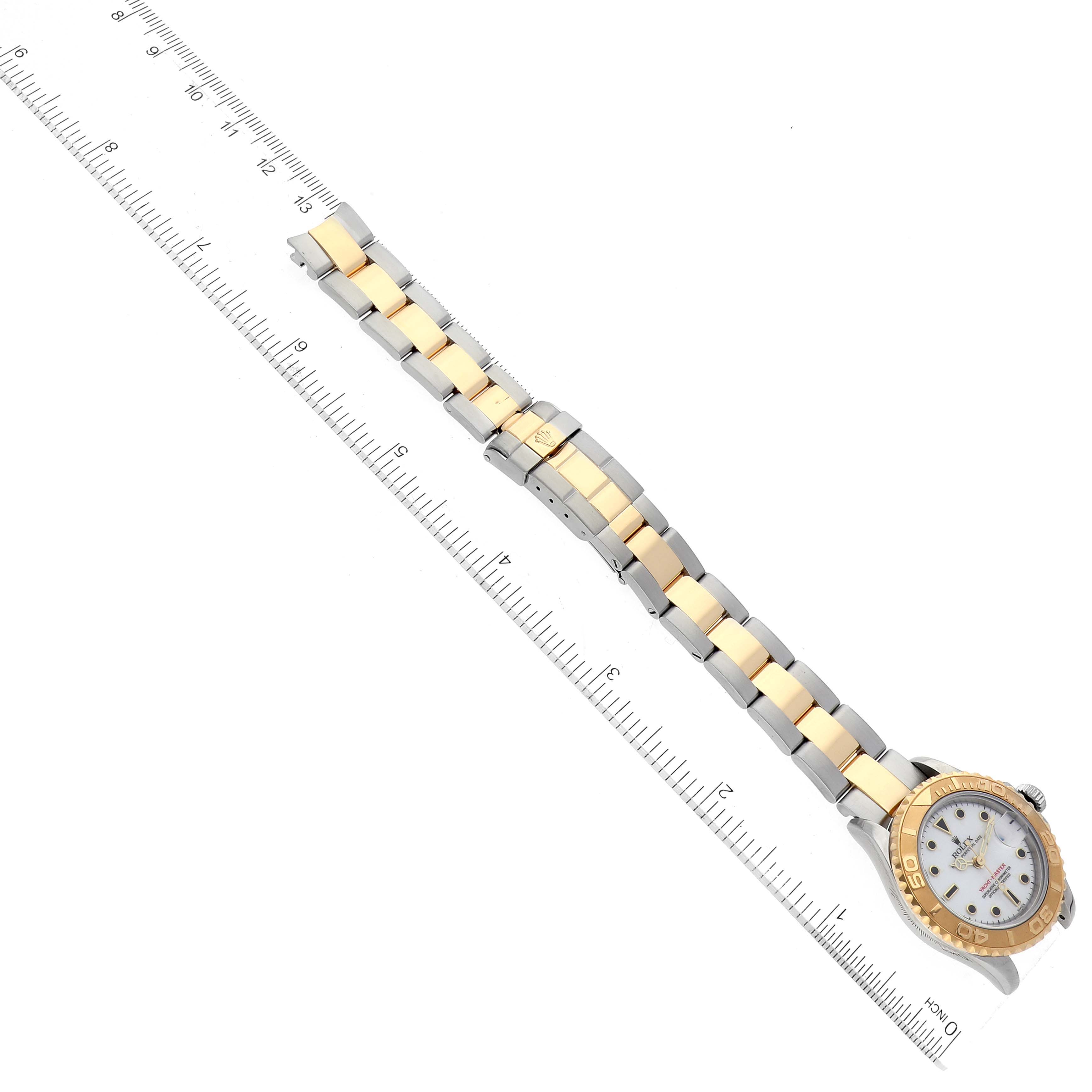 The image shows a Rolex Yacht-Master 169623 Women's Steel and Gold (two tone) White Dial 169623 Women's Steel and Gold (two tone) White Dial watch, emphasizing its two-tone metal bracelet and partial view of the watch face, positioned alongside a ruler.