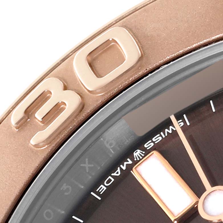 This close-up image of the Rolex Yacht-Master 268621 Men's Steel and Gold (two tone) Brown Dial 268621 Men's Steel and Gold (two tone) Brown Dial watch shows part of the bezel and dial, highlighting the "30" numeral and "Swiss Made" text.