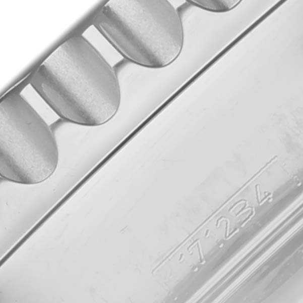 The image shows a close-up of the serrated bezel edge and part of the case back of the Breitling Navitimer AB0123 Men's Stainless Steel Silver Dial AB0123 Men's Stainless Steel Silver Dial watch.