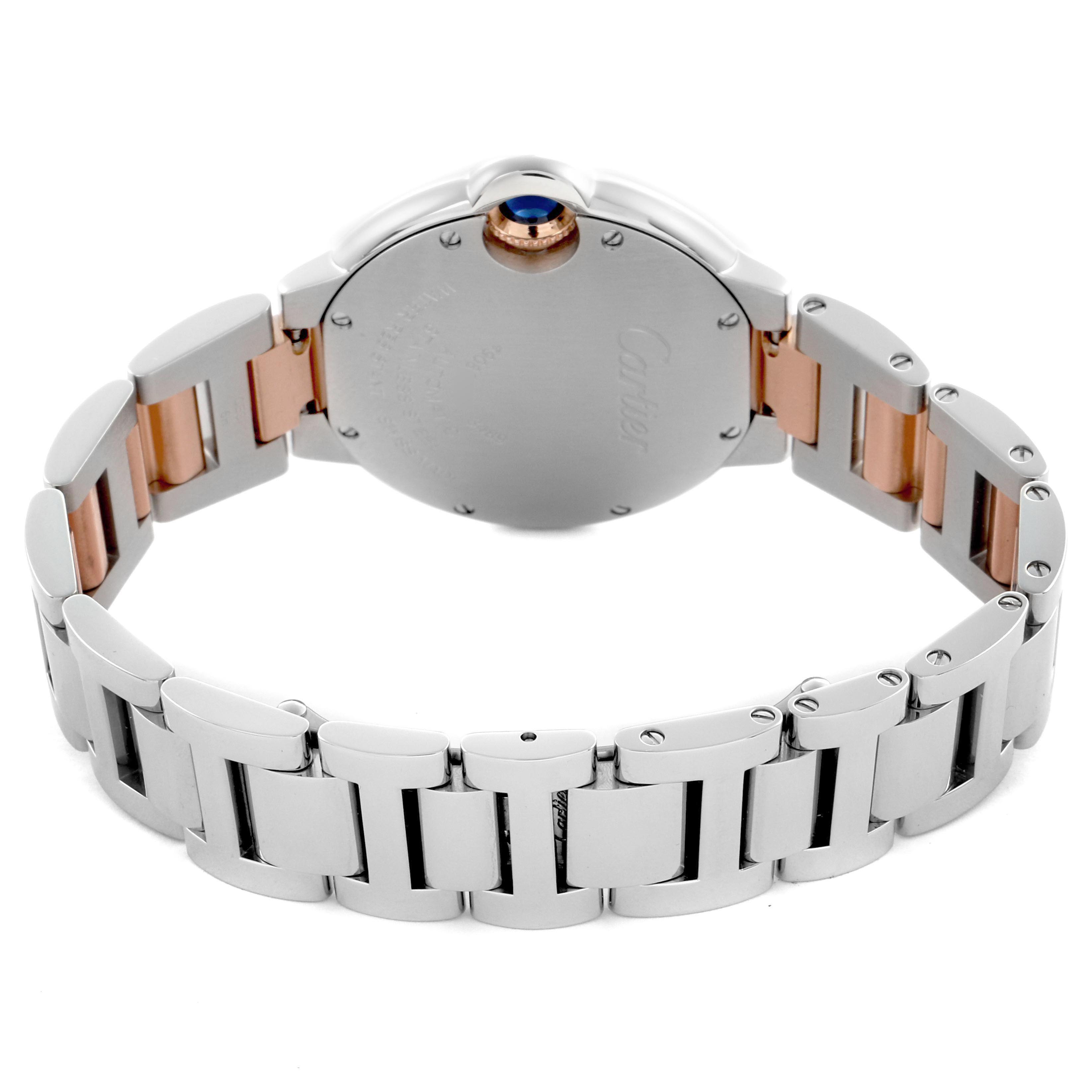 The Cartier Ballon Bleu WE902044 Women's Steel and Gold (two tone) Silver Dial WE902044 Women's Steel and Gold (two tone) Silver Dial watch is shown from the back, detailing the bracelet and a glimpse of the crown with a blue cabochon.