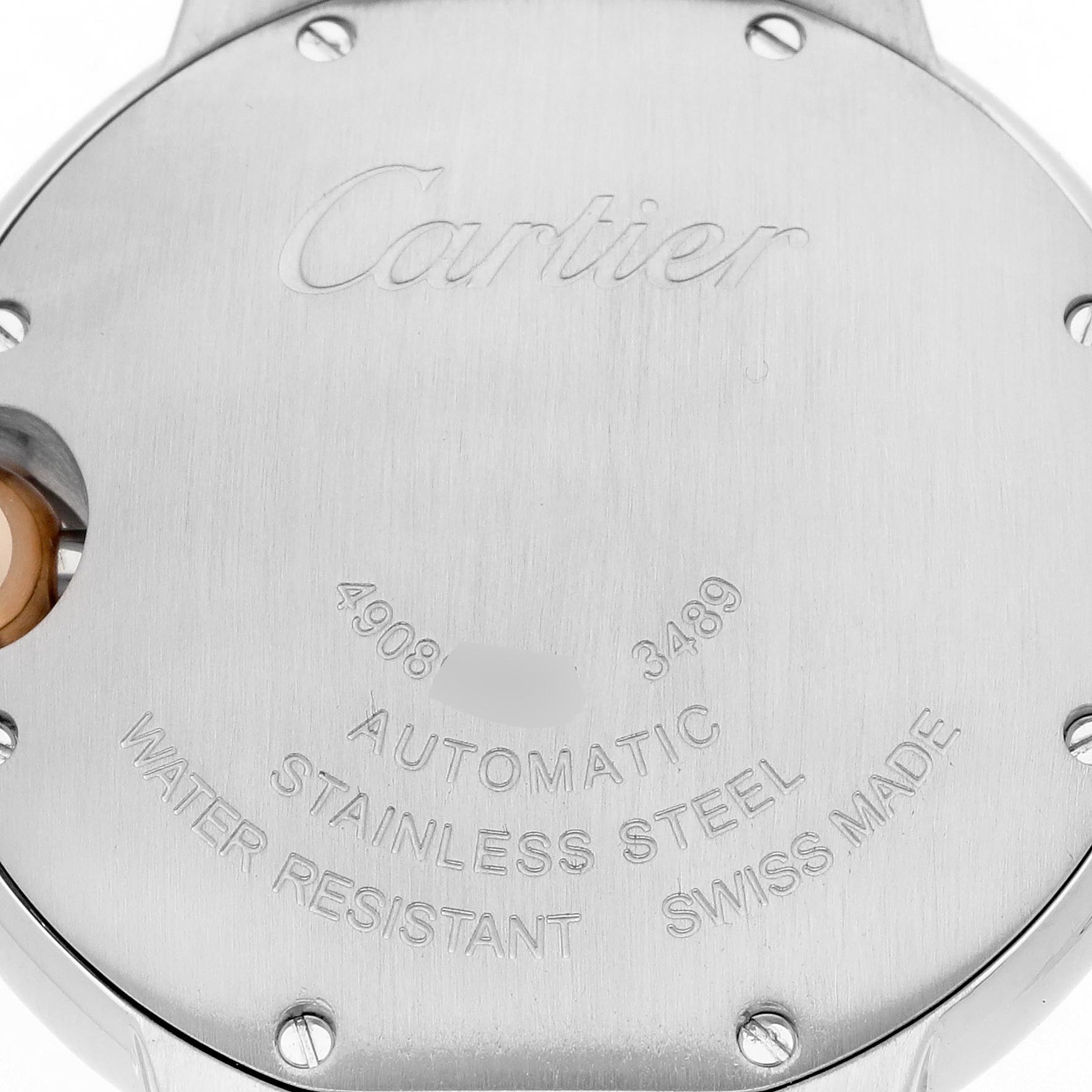 The image shows the back case of a Cartier Ballon Bleu WE902044 Women's Steel and Gold (two tone) Silver Dial WE902044 Women's Steel and Gold (two tone) Silver Dial watch, highlighting its engravings and metallic texture.