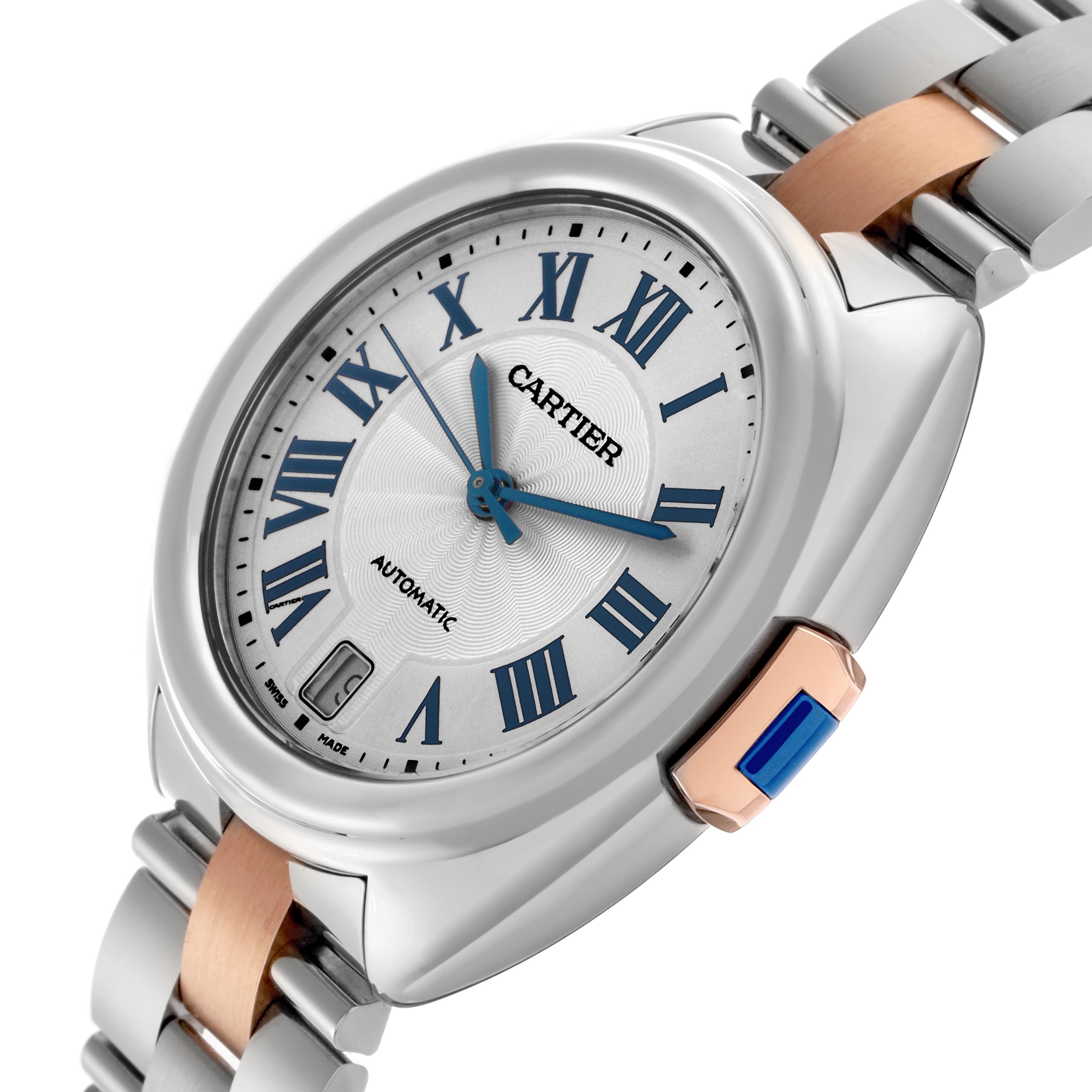 The Cartier Clé watch is shown at an angled side view, highlighting the dial, Roman numerals, and crown.