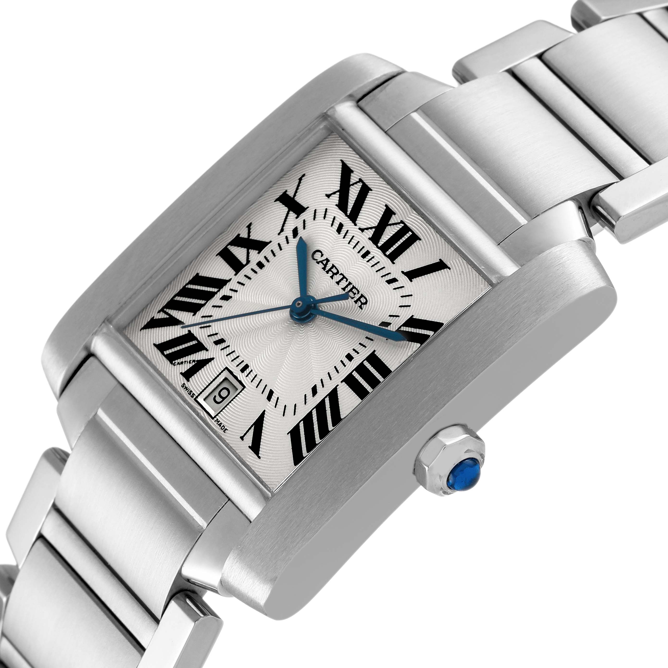 The Cartier Tank Française watch is shown at an angled view, highlighting the dial, crown with a blue cabochon, and the metal bracelet.