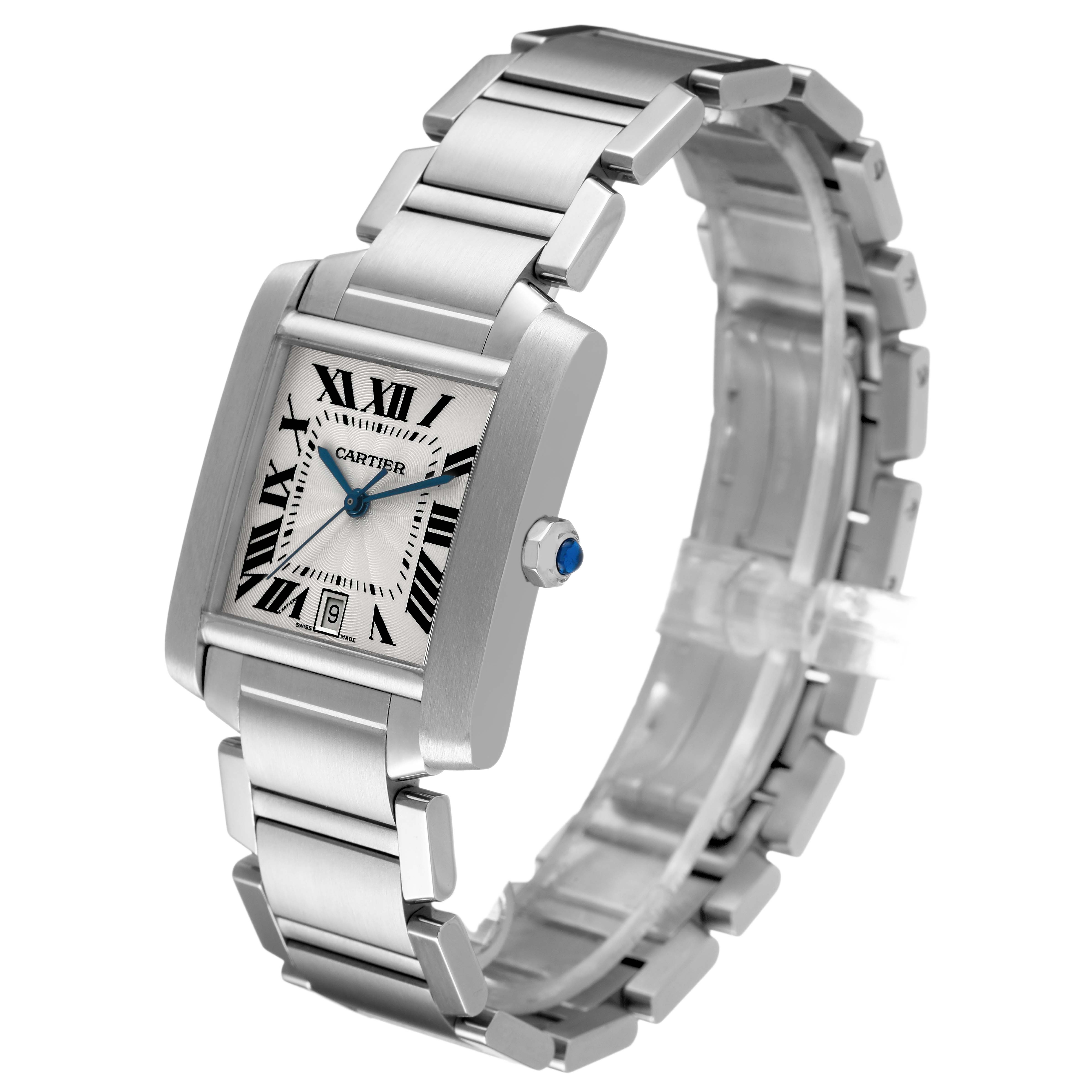 The Cartier Tank Française watch is shown at an angled view, displaying the bracelet, dial, and crown with a blue gem.