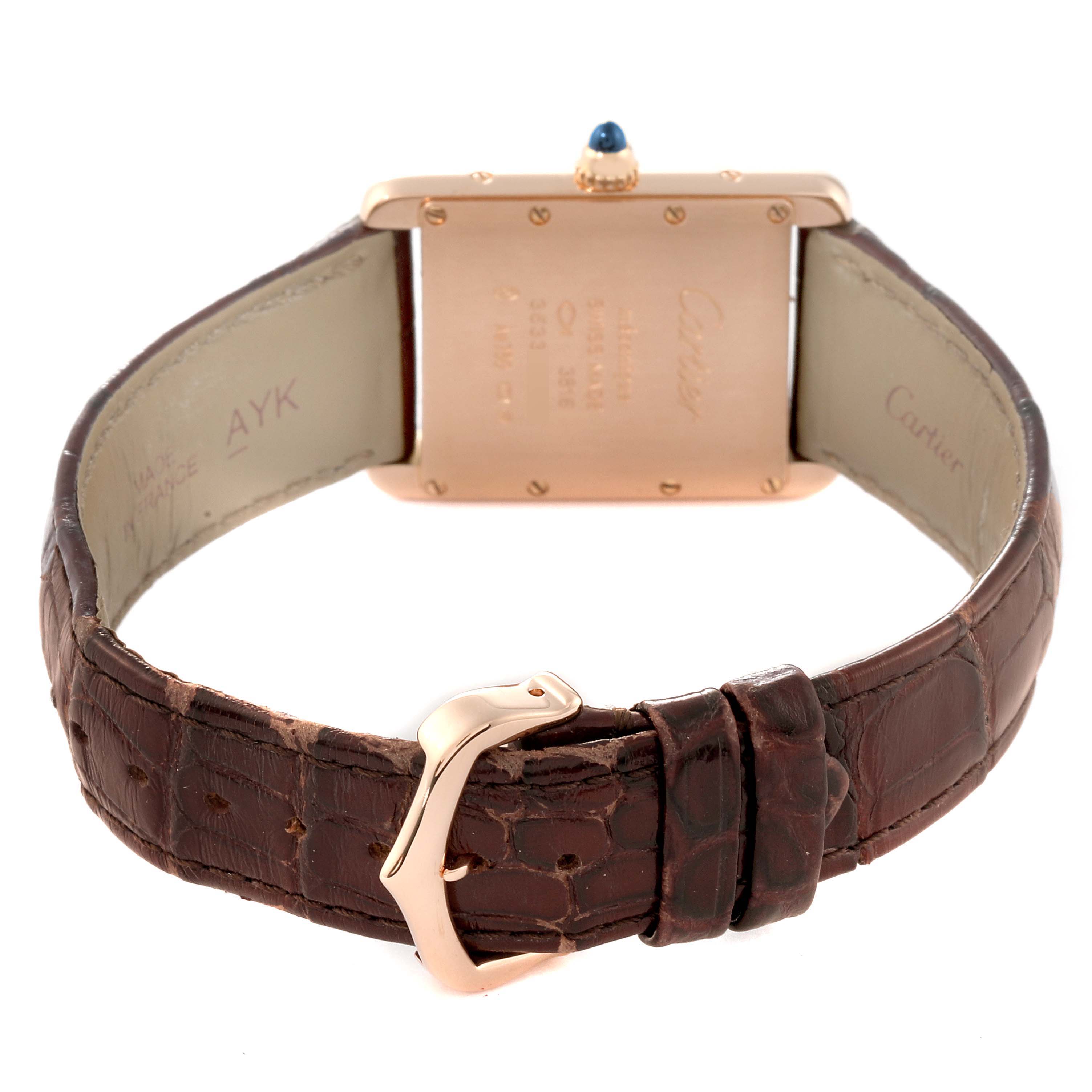 The image shows the back view of a Tank Louis watch by Cartier, highlighting the case back and leather strap.