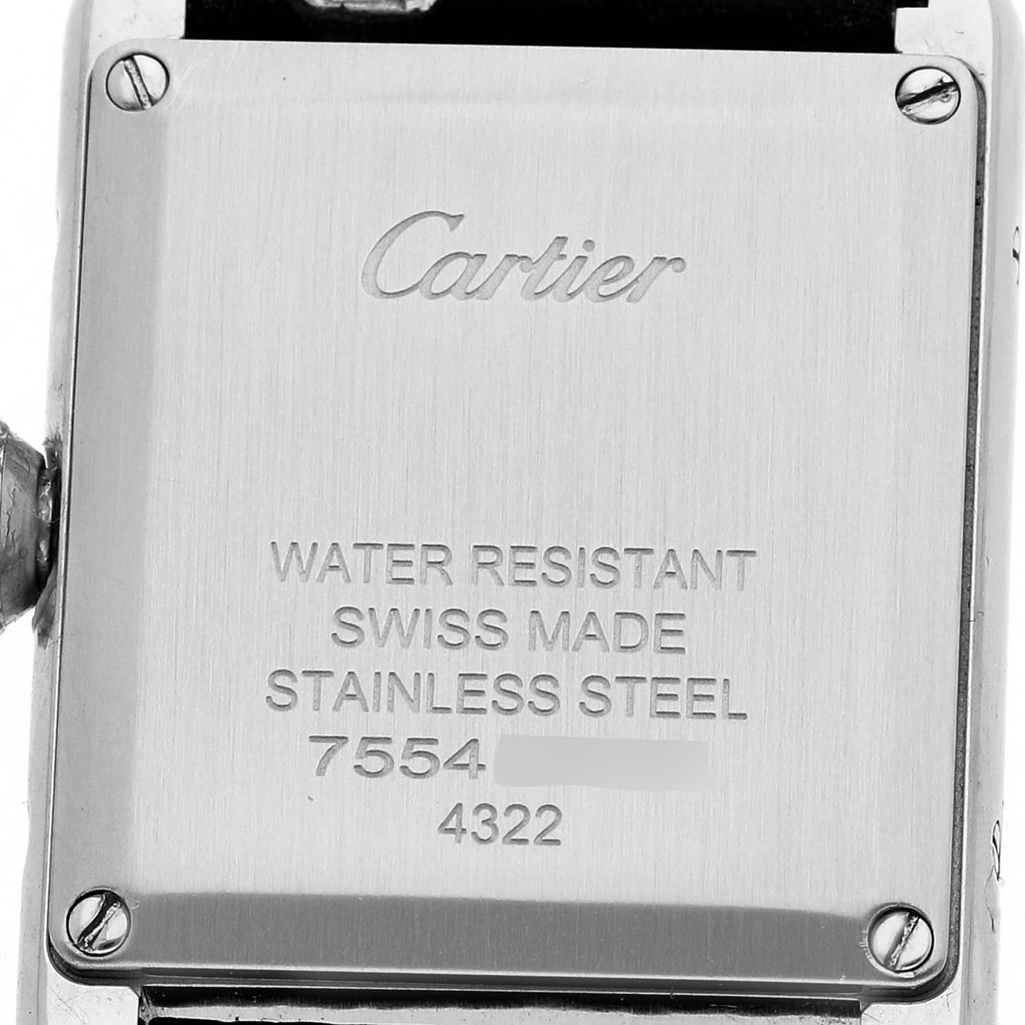 The image shows the back plate of a Cartier Tank Must WSTA0042 Men's Stainless Steel Silver Dial watch, highlighting engraved details like brand and material information.