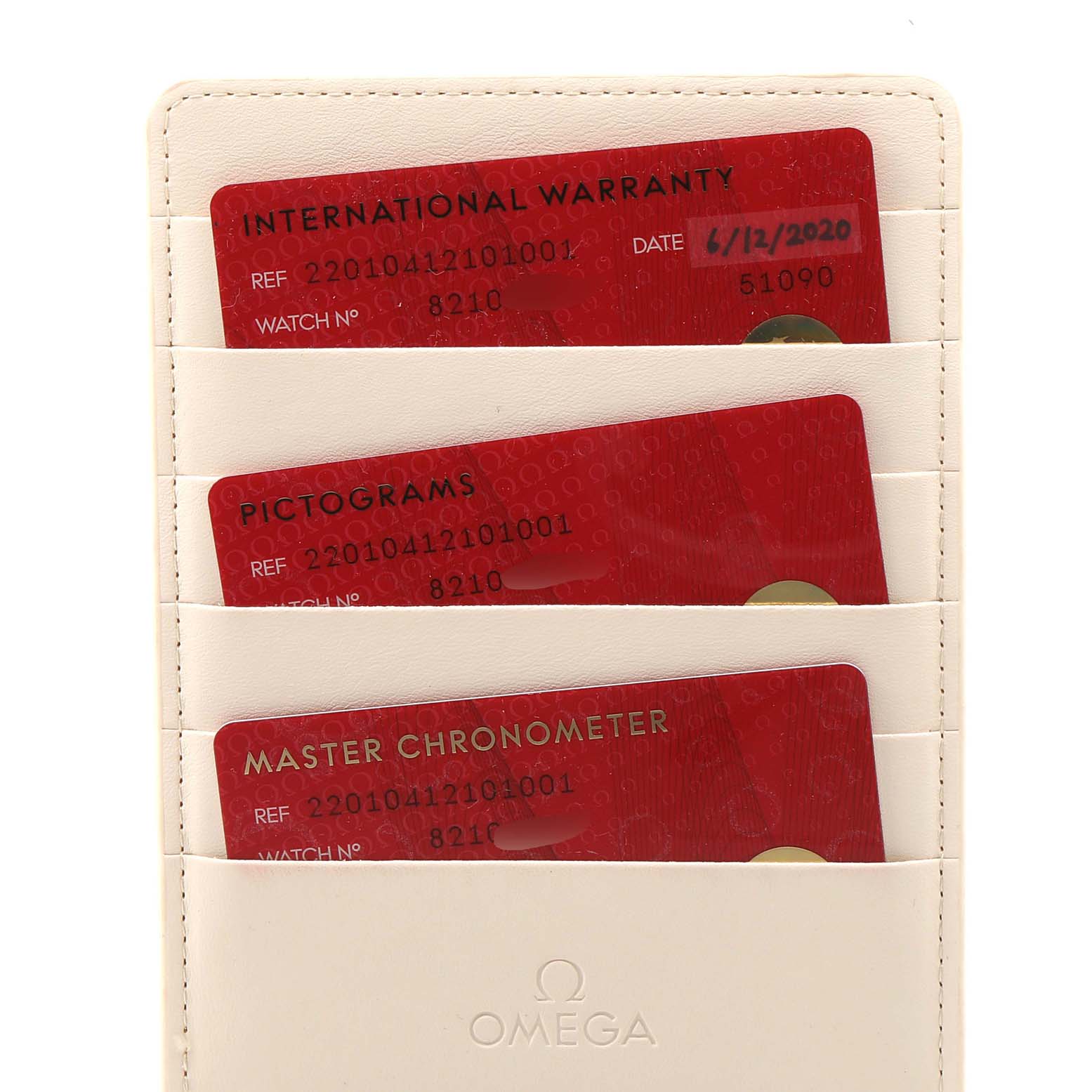 The image shows three red Omega Aqua Terra 220.10.41.21.01.001 Men's Stainless Steel Black Dial 220.10.41.21.01.001 Men's Stainless Steel Black Dial model cards in a beige cardholder, including an International Warranty card, Pictograms card, and Master Chronometer card.