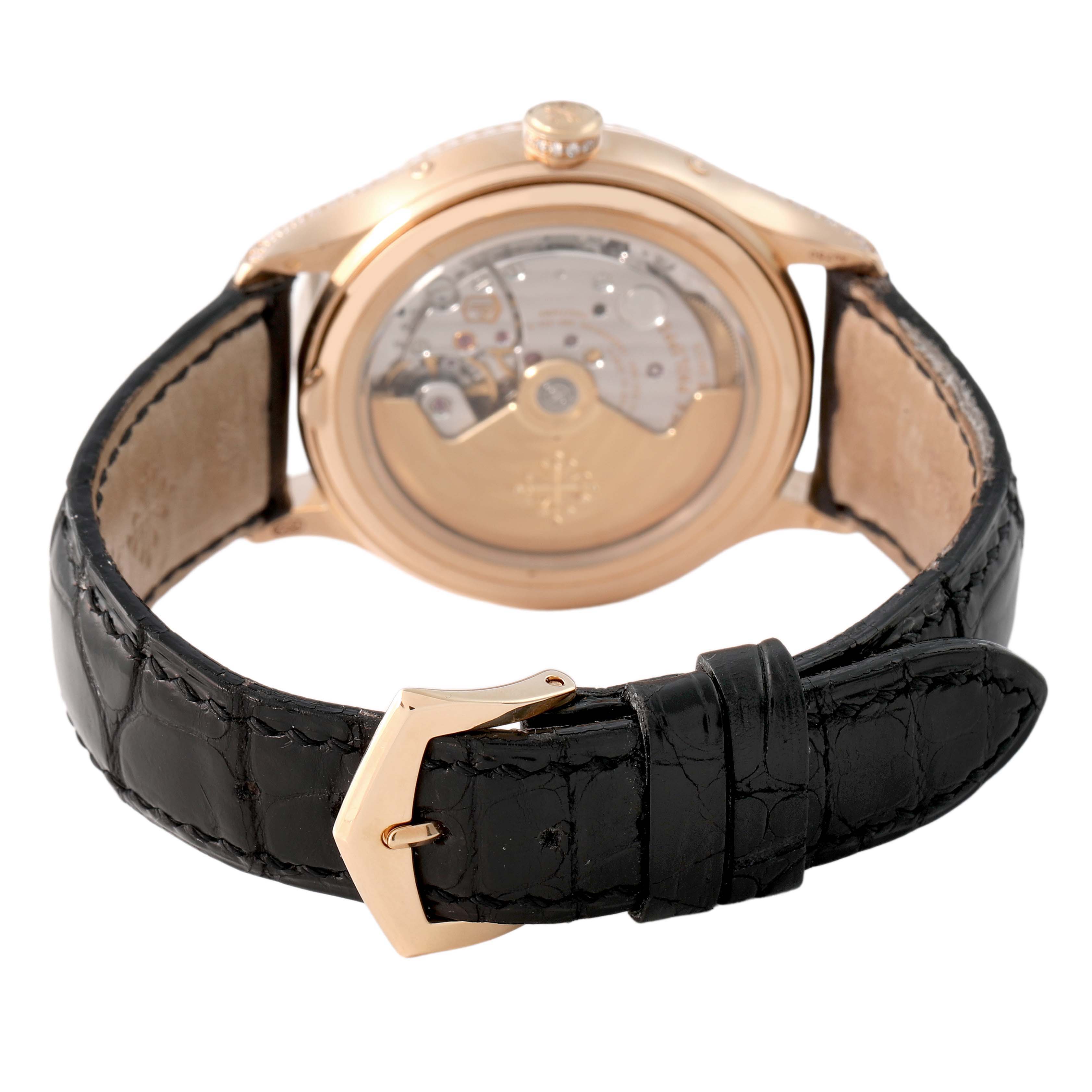 The image shows the Patek Philippe Complications 4947R-001 Men's Rose Gold Silver Dial model from the back, displaying the movement and black leather strap with a gold buckle.