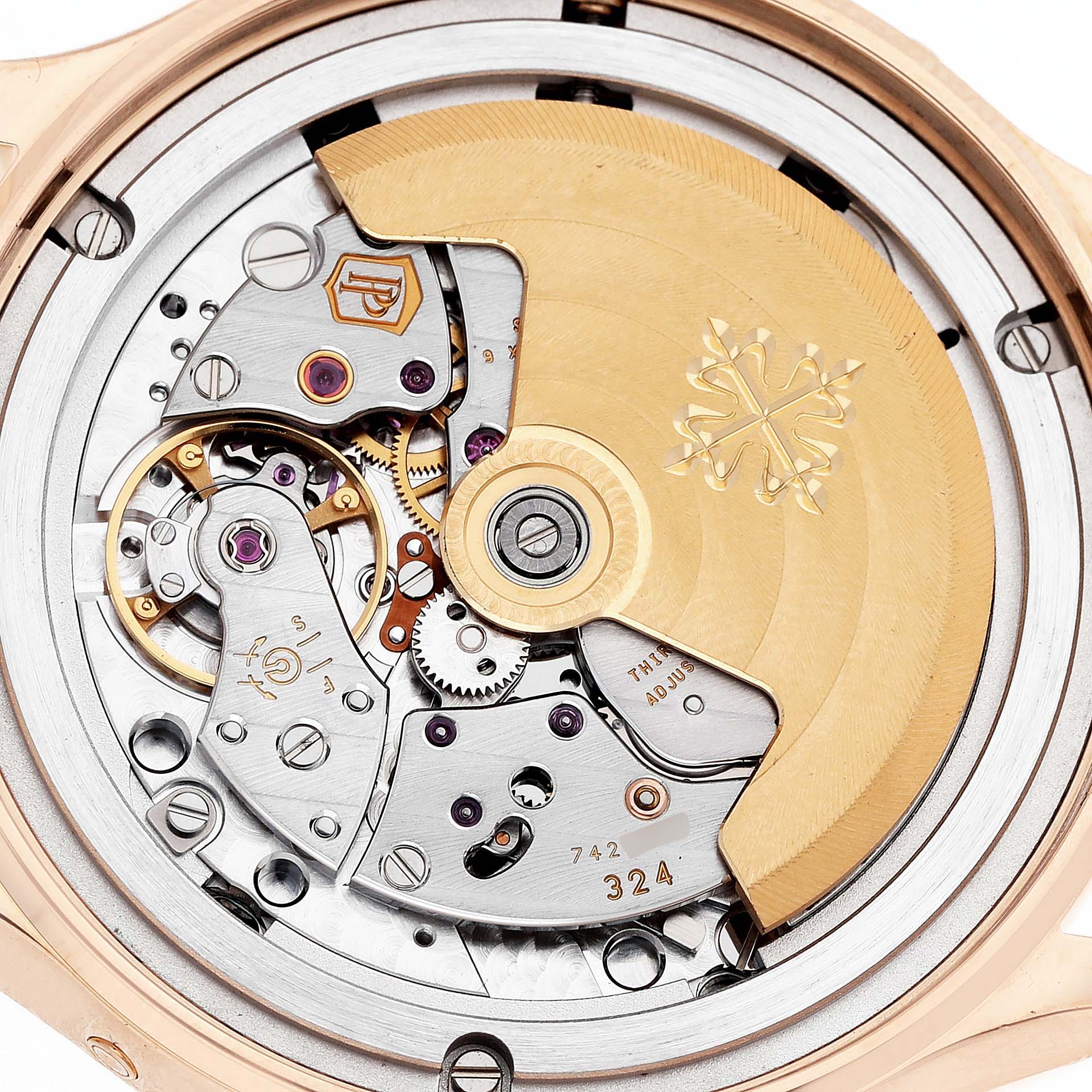The image shows the back view of a Patek Philippe Complications 4947R-001 Men's Rose Gold Silver Dial watch, focusing on its intricate movement and rotor.