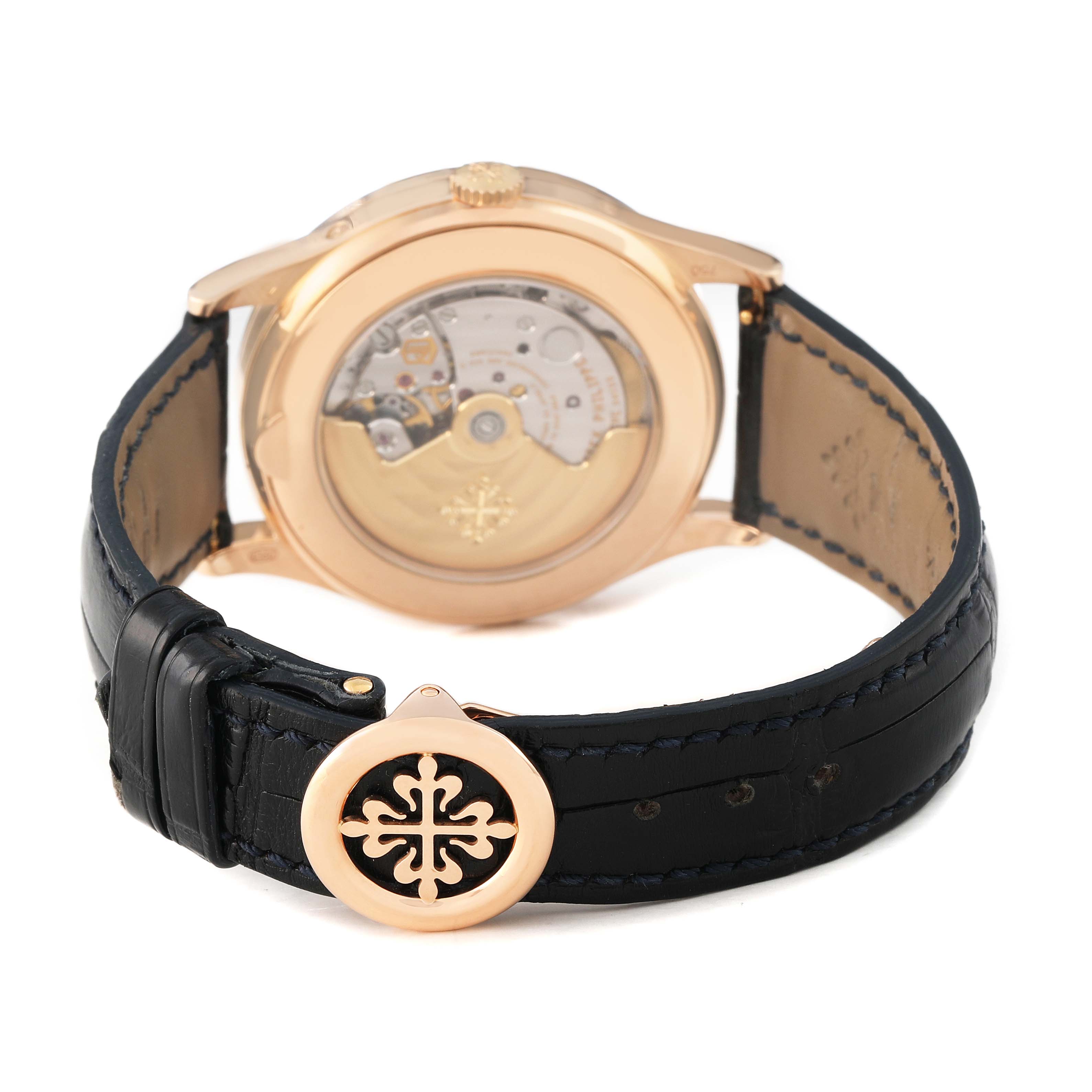 The Patek Philippe Complications 5396R 5396 Men's Rose Gold Blue Dial model is shown from the rear, displaying the watch's movement and leather strap with a decorative clasp.