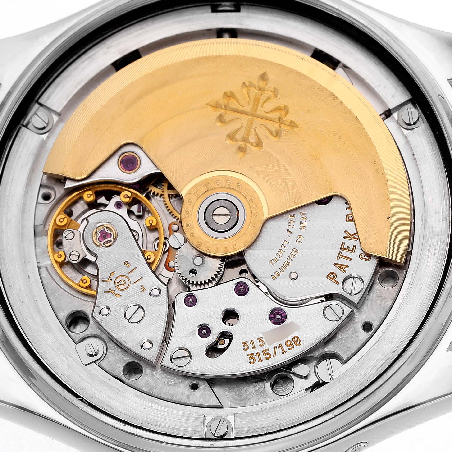 The image shows the movement of a Patek Philippe Complications 5037G 5037 Men's White Gold White Dial watch from the back, highlighting the rotor and internal mechanisms.