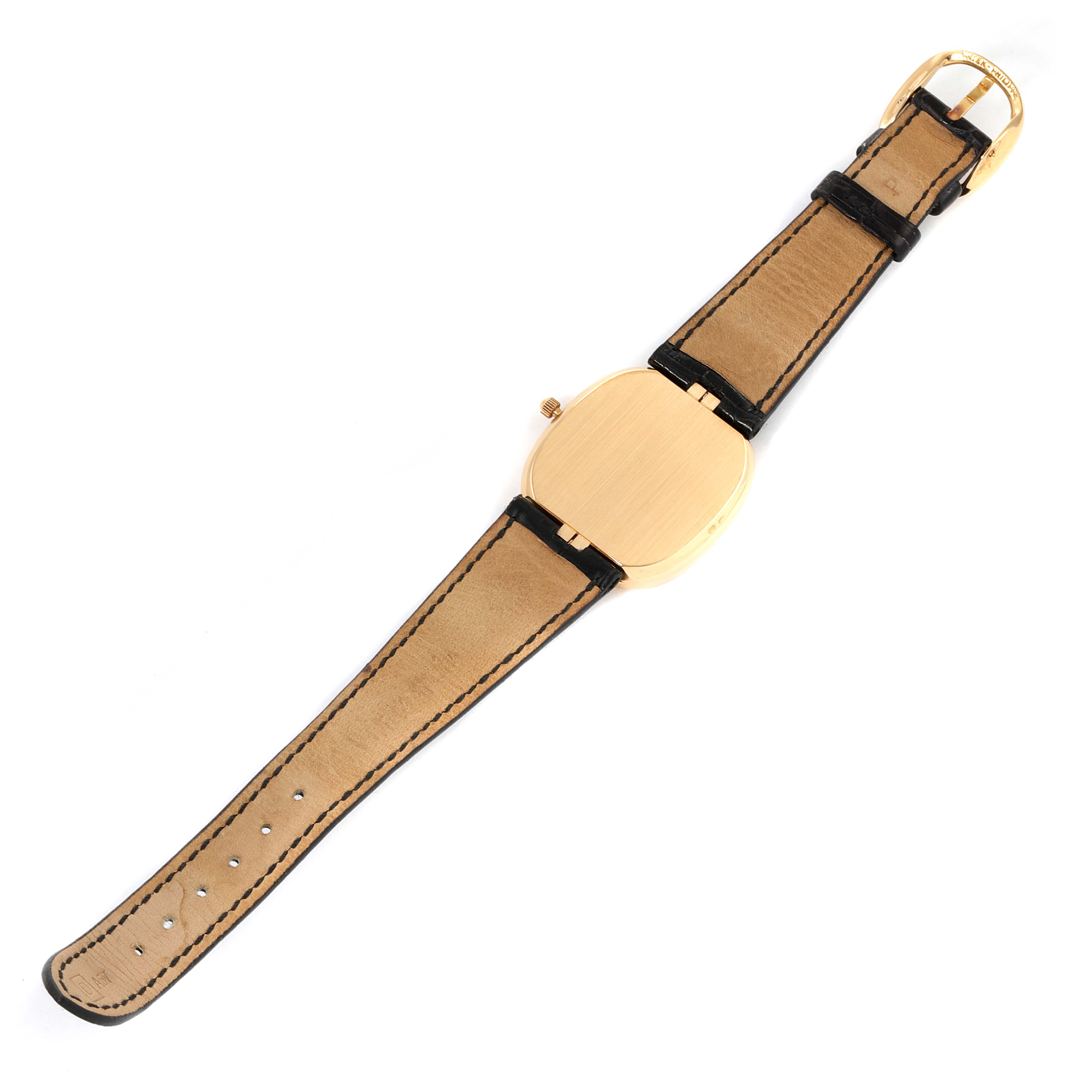 The image shows the back of a Patek Philippe Golden Ellipse 3747 Men's Yellow Gold Blue Dial 3747 Men's Yellow Gold Blue Dial watch laid flat, highlighting the strap and buckle.