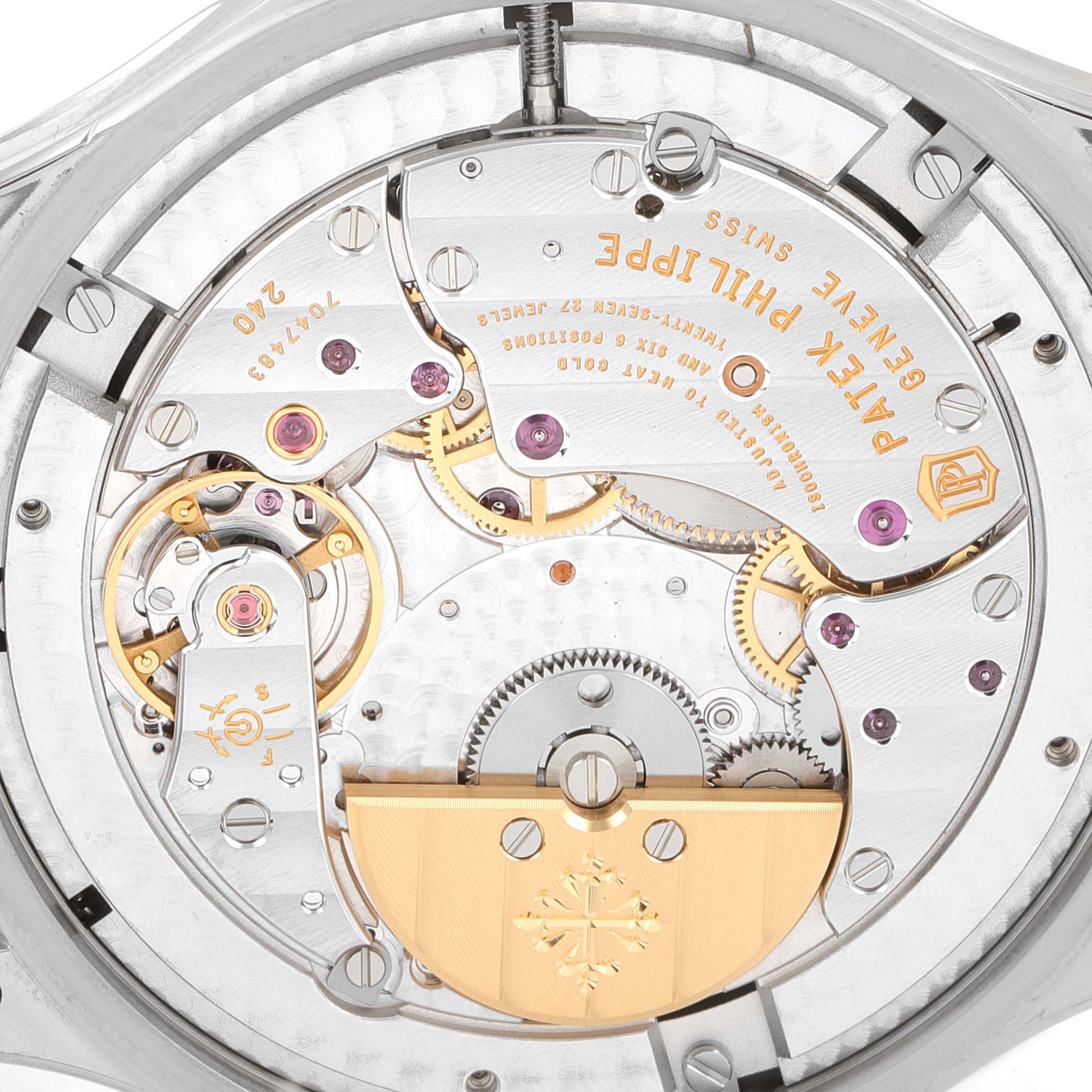 This image shows the intricate movement details and inner workings of a Patek Philippe Complications 5327G-001 Men
s White Gold Blue Dial 5327G-001 Men
s White Gold Blue Dial watch from a close-up angle.